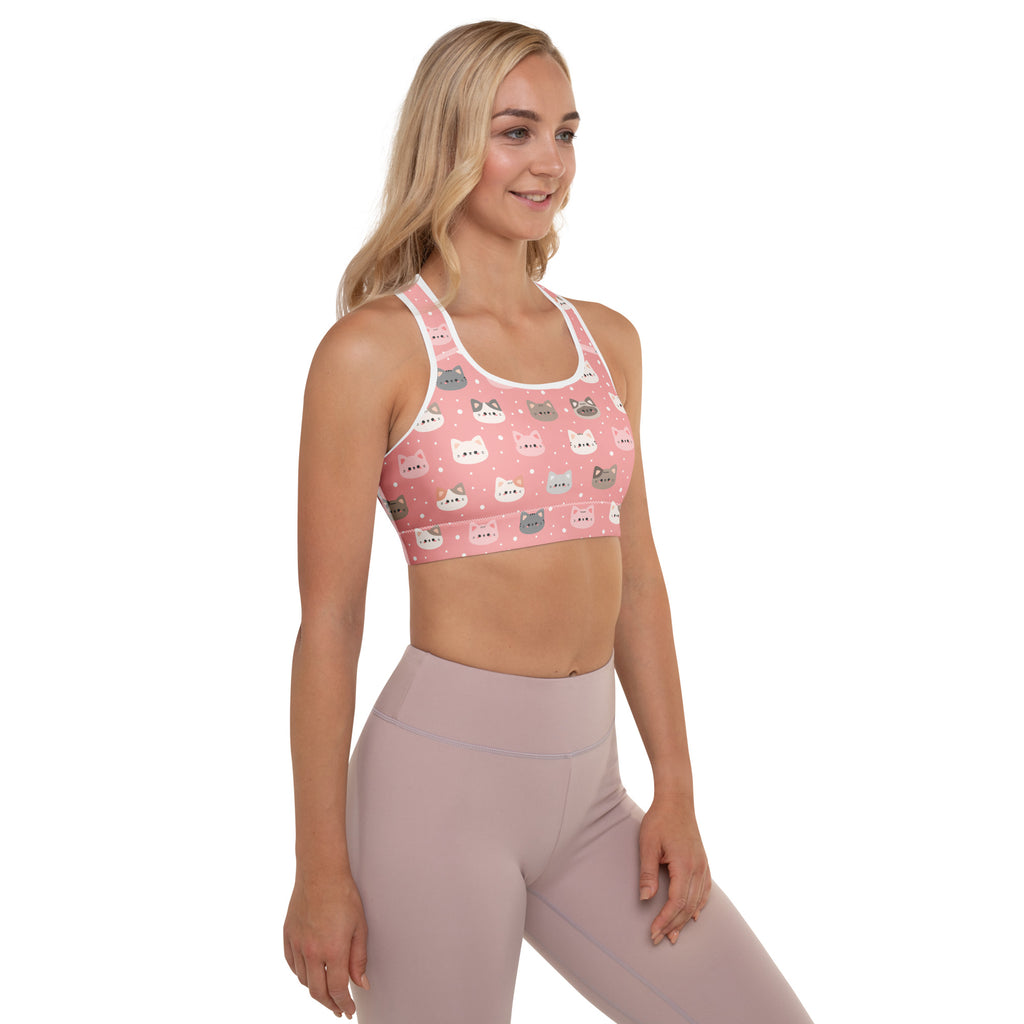 Women’s cute pink padded sports bra with playful cartoon cat faces pattern and supportive racerback straps