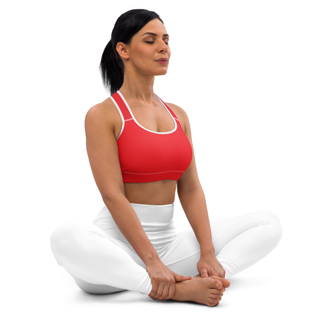 Women’s red padded sports bra with white trim, buttery soft fabric, supportive fit, and quick-dry material