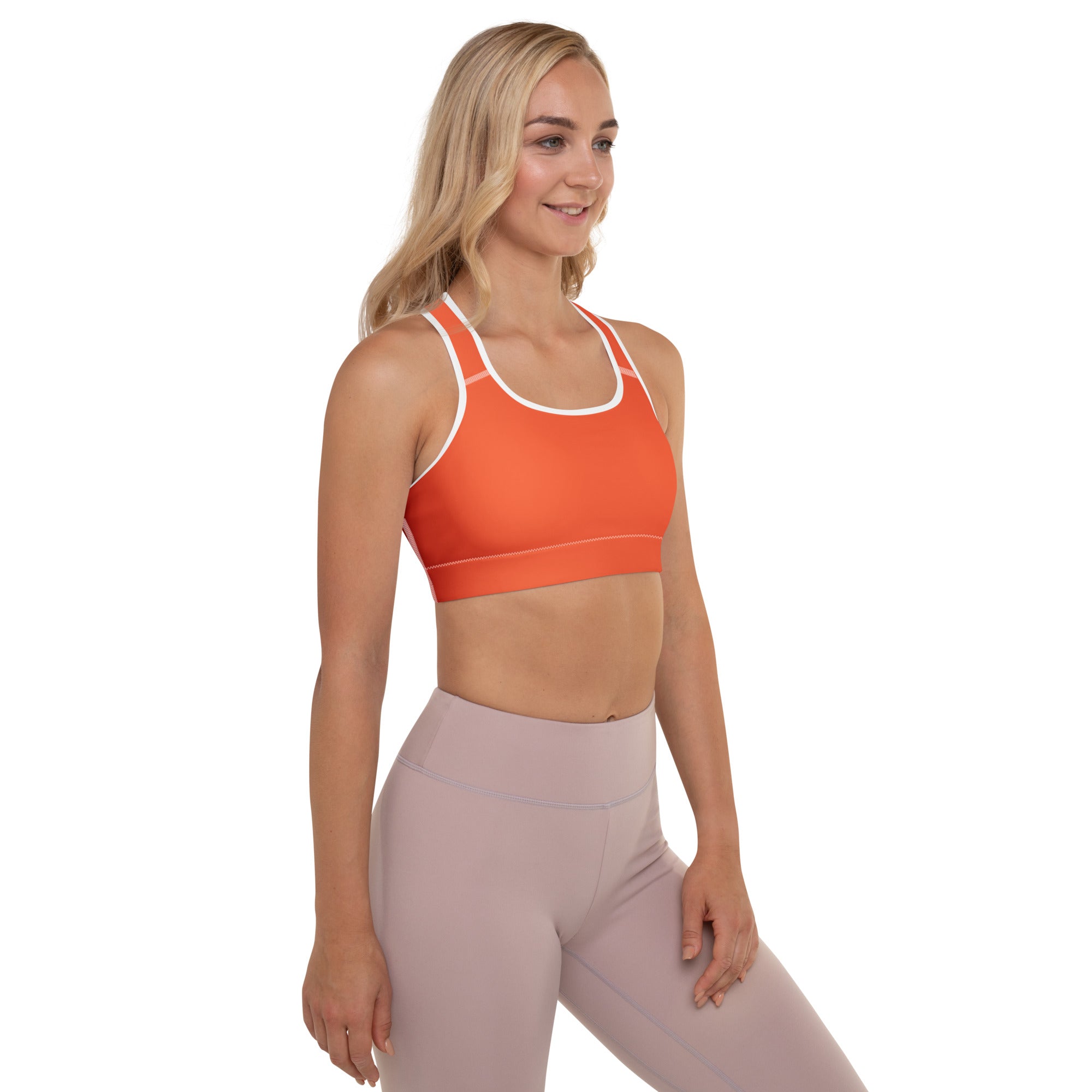 Women’s orange padded sports bra with white trim and racerback straps made of buttery soft quick-dry fabric