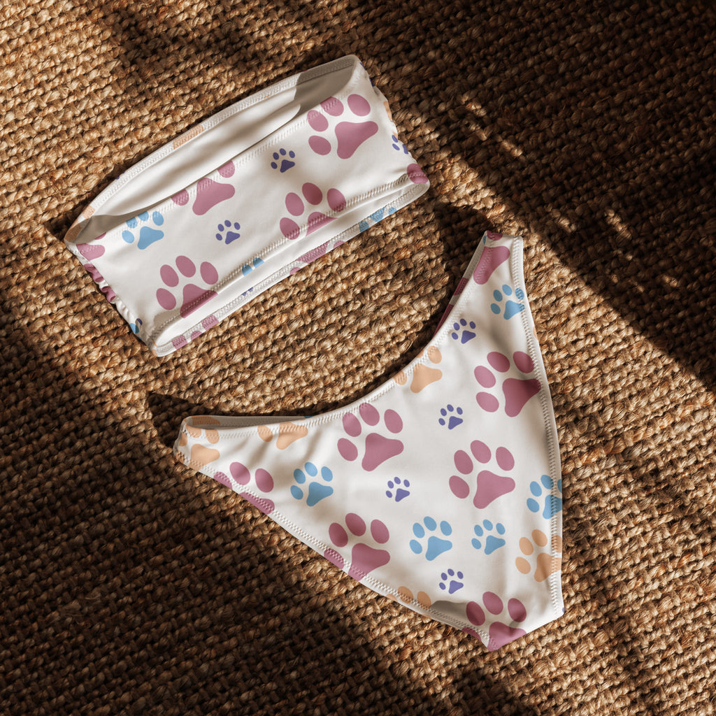 White bikini set with colorful pink blue and purple paw prints made from quick drying recycled fabric with upf 50+