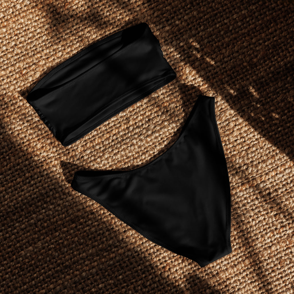 Women’s black recycled bandeau bikini set with strapless top and high-cut briefs made of quick drying stretchy fabric with upf 50+