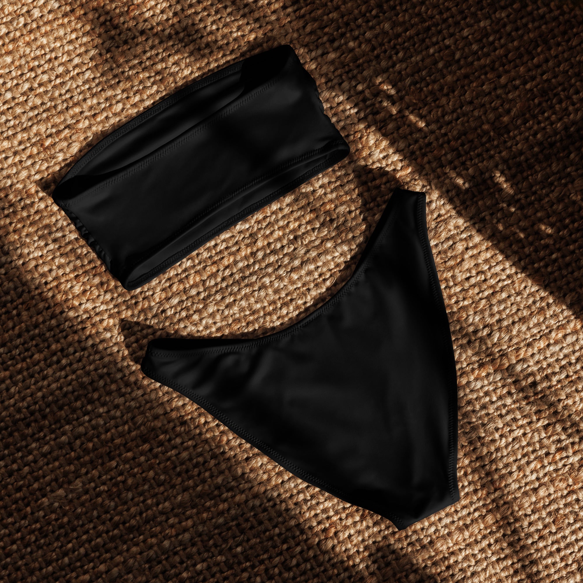 Women’s black recycled bandeau bikini set with strapless top and high-cut briefs made of quick drying stretchy fabric with upf 50+