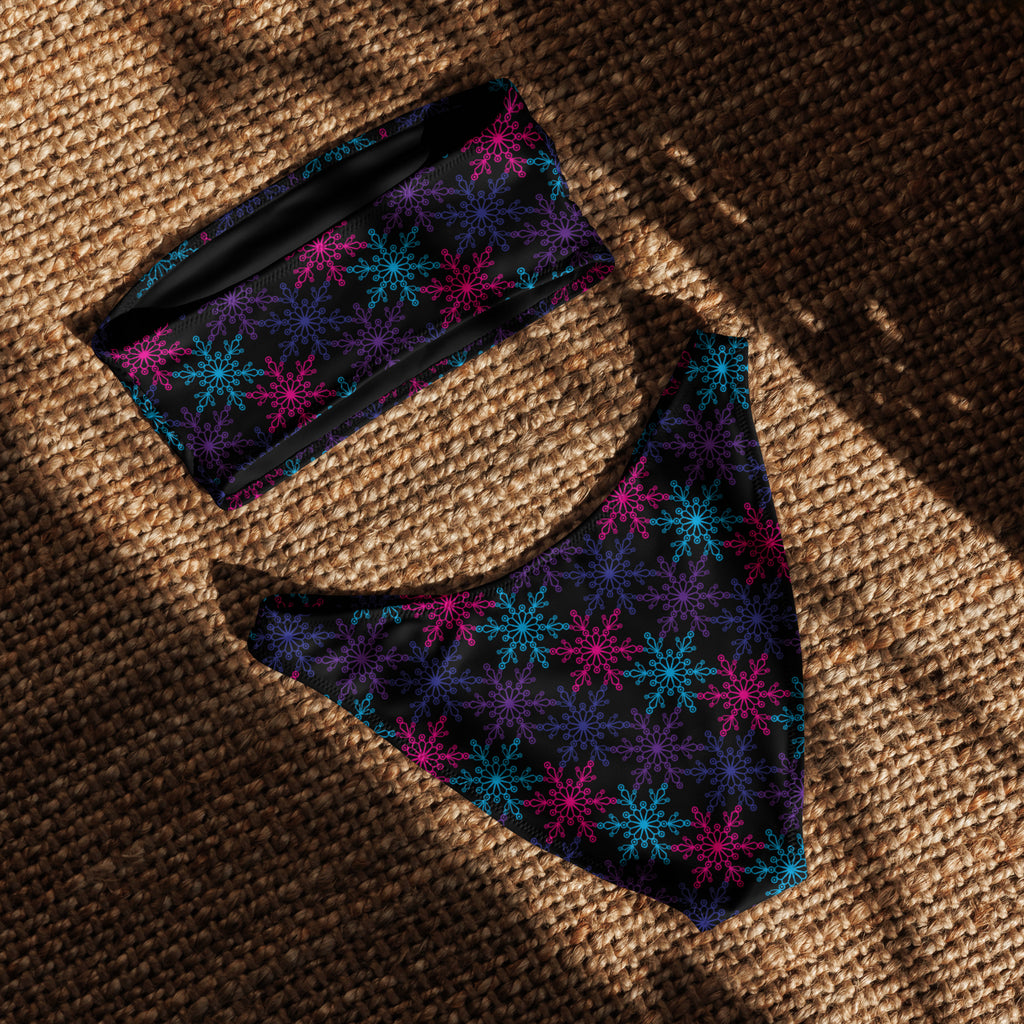 Black fabric dog bandana and collar with vibrant pink blue and purple snowflake patterns matching neon bikini design