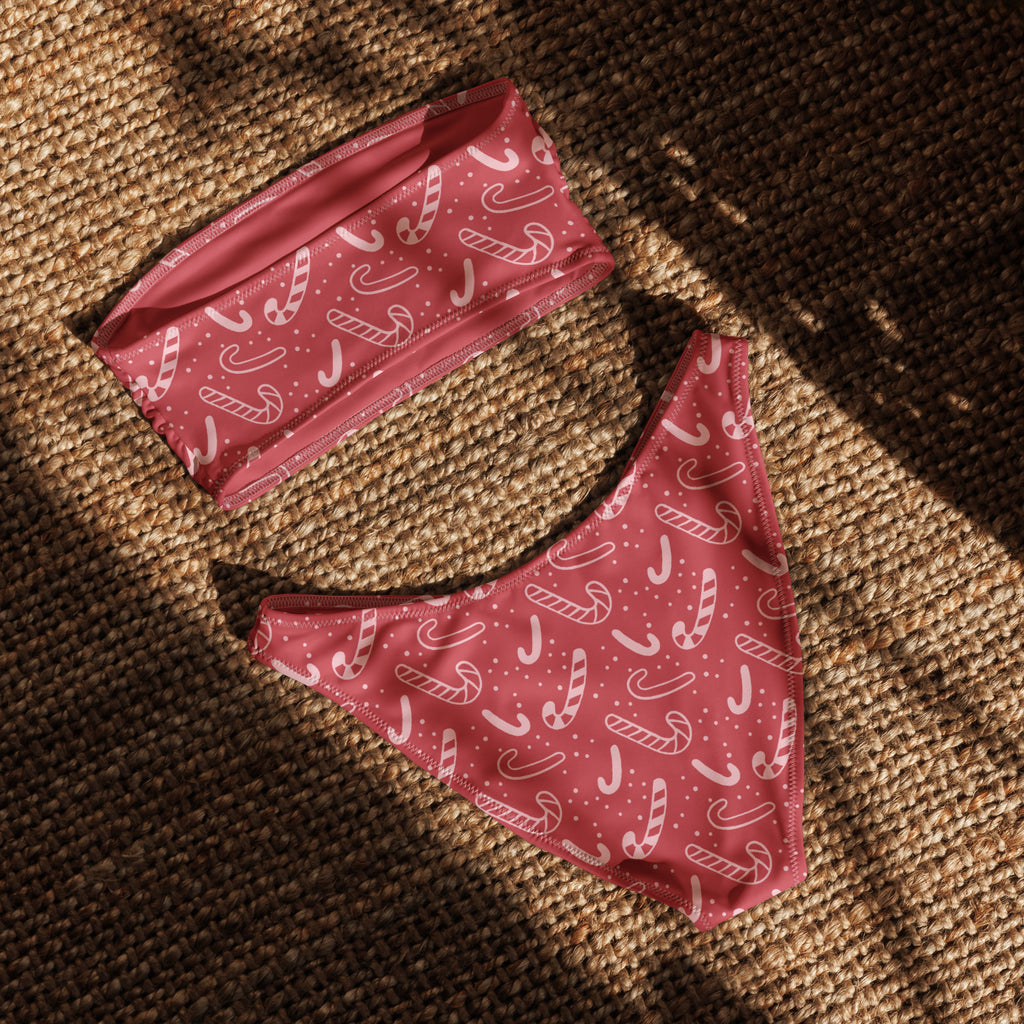 Women’s red candy cane recycled bandeau bikini with pink candy cane pattern white outlines and quick drying fabric