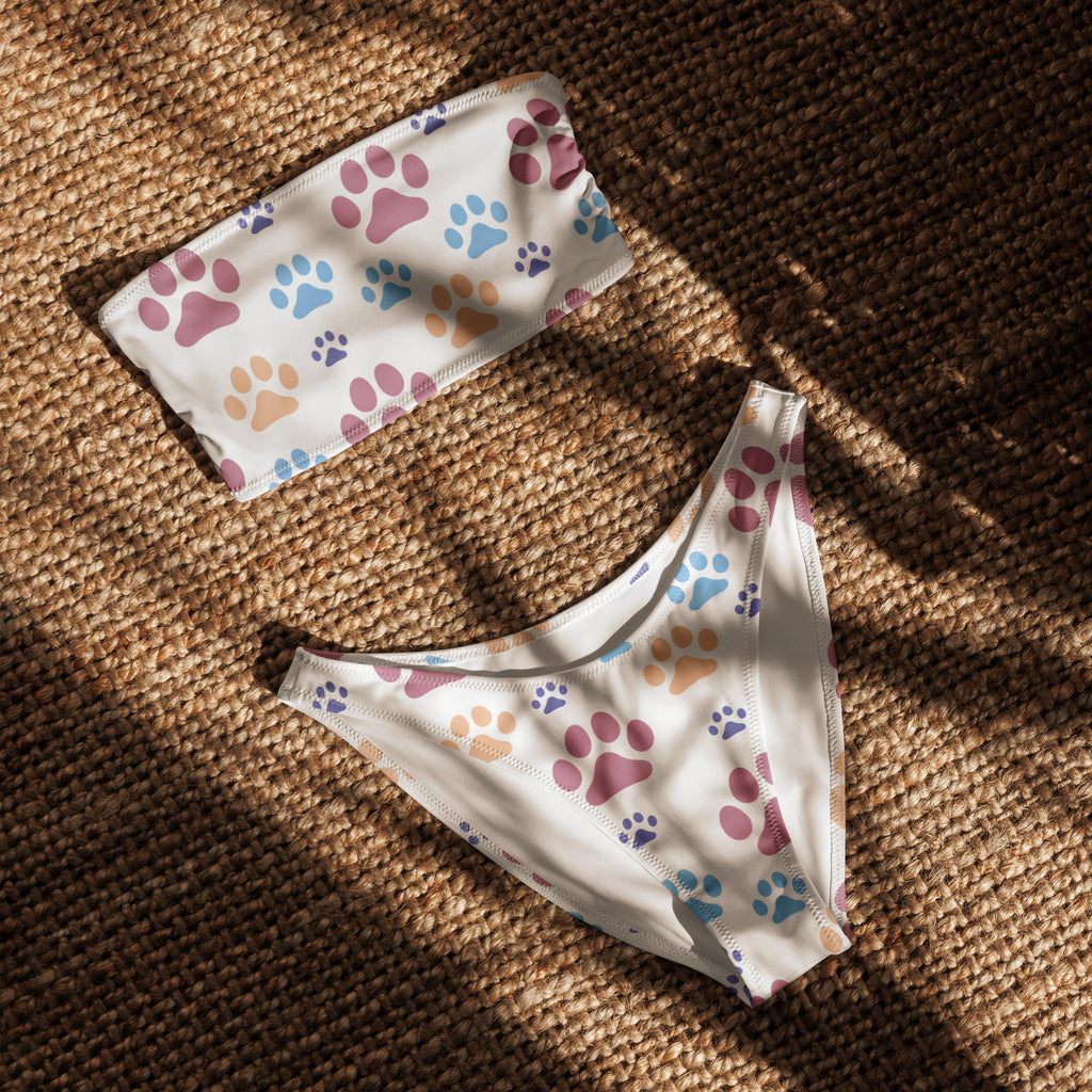 White women’s bandeau bikini set with colorful paw prints in pink blue purple beige made from quick drying recycled fabric with upf 50+