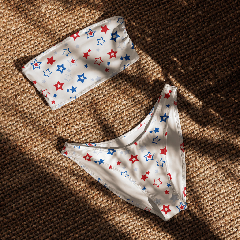White bikini set with red blue and silver star pattern featuring bandeau top and high waisted bottoms in quick drying fabric with upf 50+