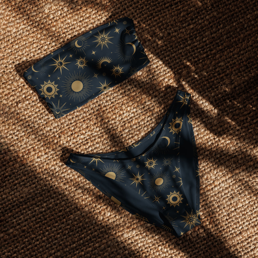 Dark blue bandeau bikini set with gold suns moons and stars pattern made from quick drying recycled fabric with upf 50+