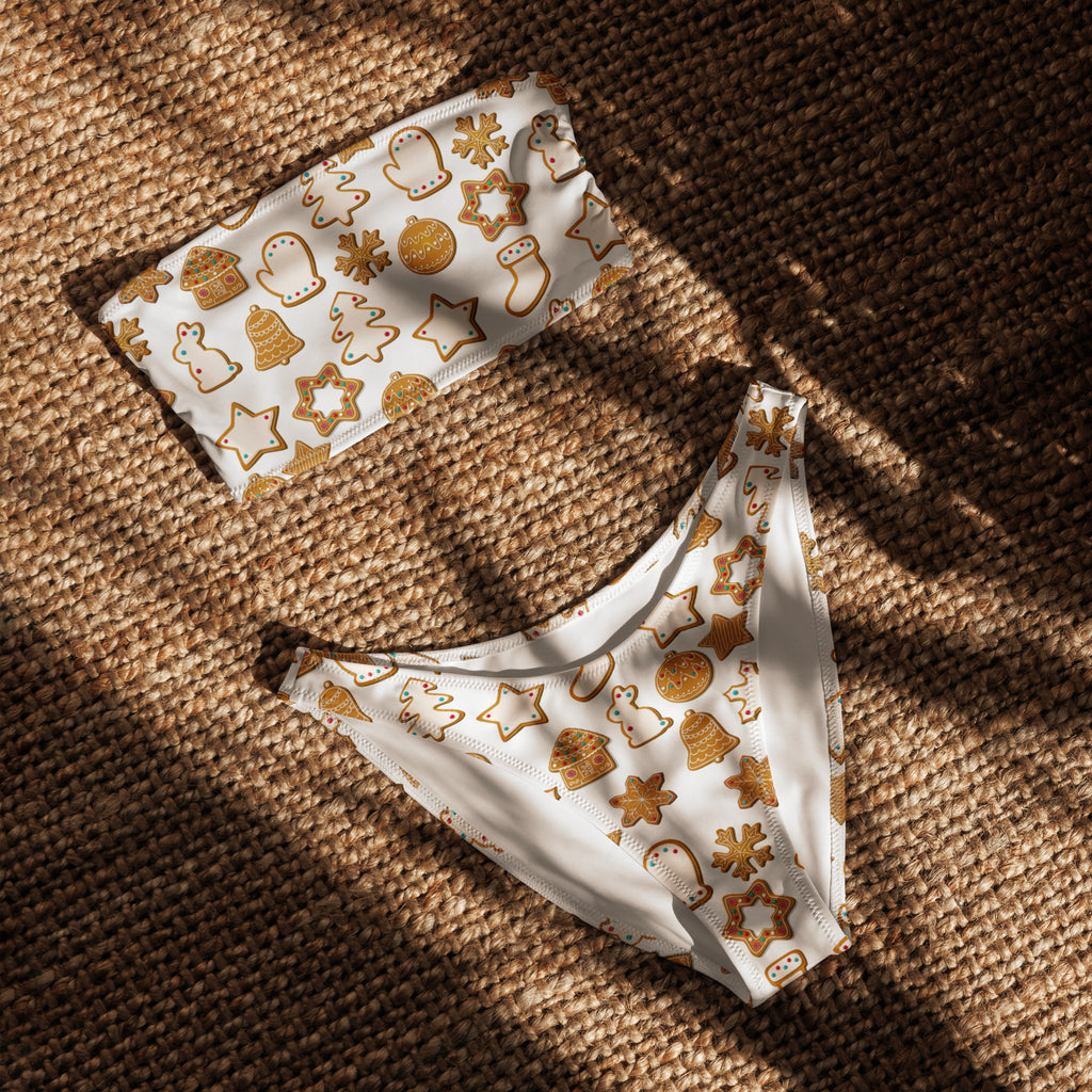 White bikini briefs with festive gold holiday cookie and star pattern made from quick-drying recycled fabric with upf 50+