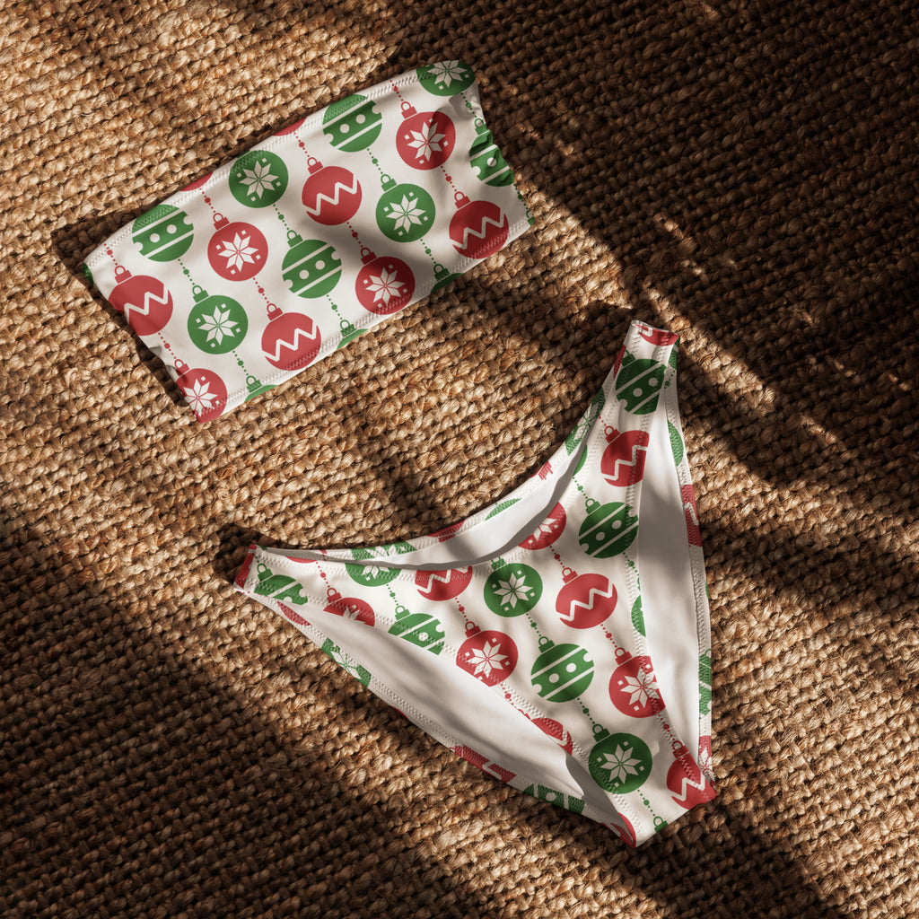 White bandeau bikini set with festive red and green christmas ornaments and snowflakes made from recycled quick drying fabric with upf 50+