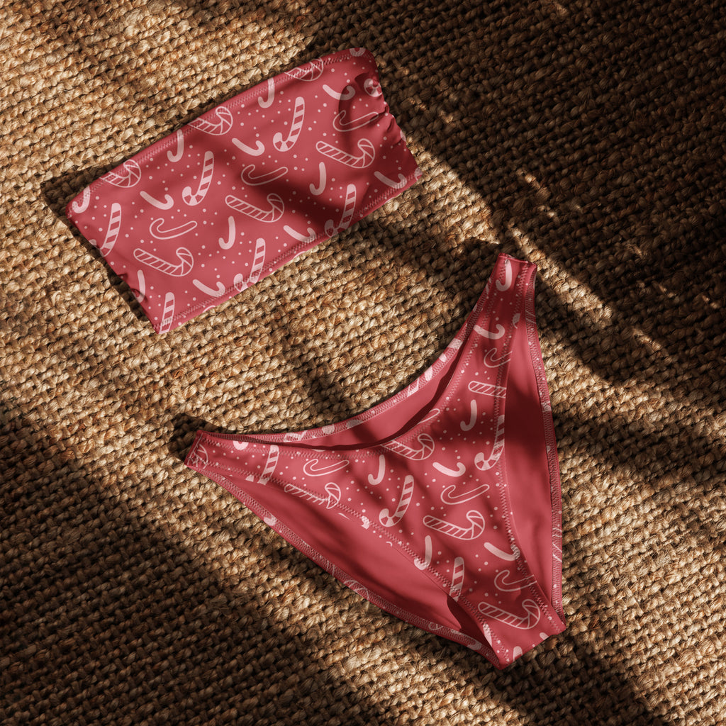 A pair of women’s red candy cane pattern recycled bandeau bikini underwear with white stripes and quick drying fabric
