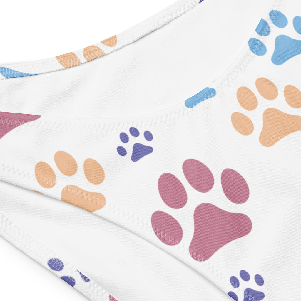 White bandeau bikini top with colorful blue pink and orange paw prints made from quick drying recycled fabric with UPF 50+