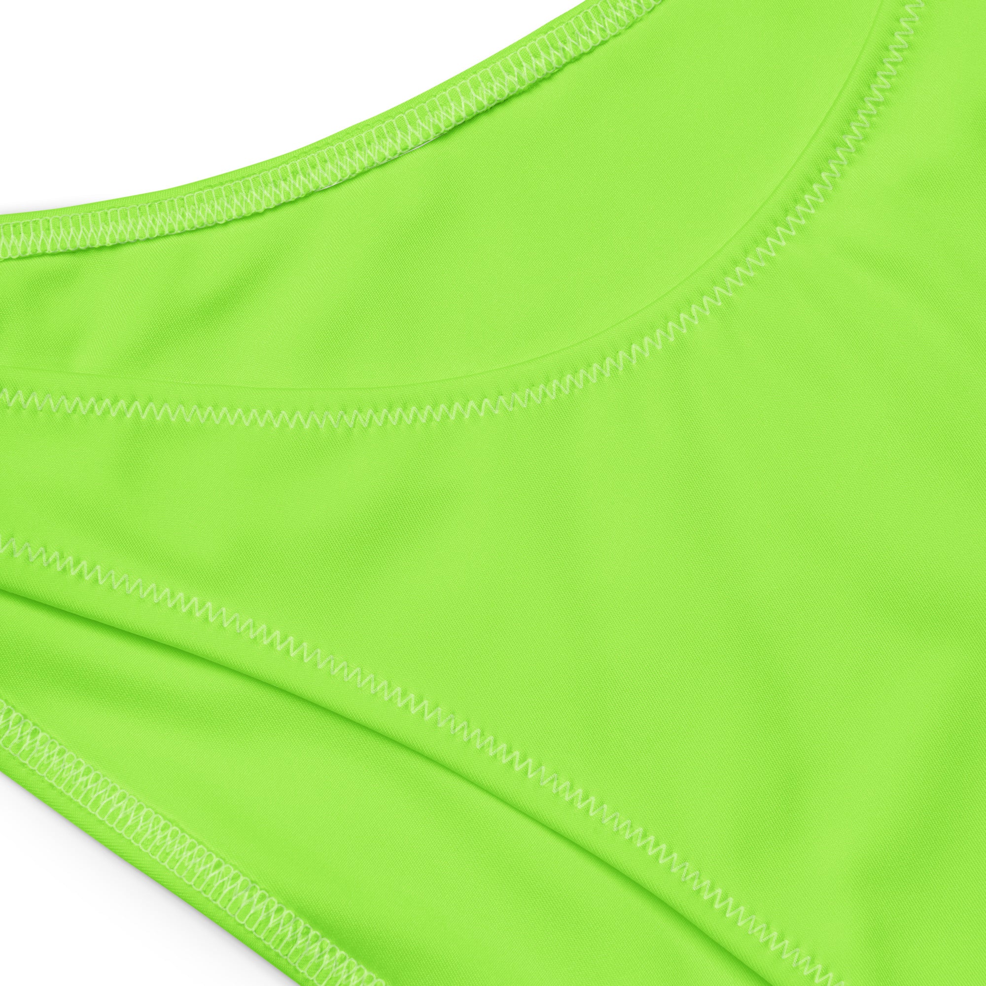 Bright neon green athletic tank top with smooth stretchy fabric and zigzag seams for quick drying and UPF 50+ protection