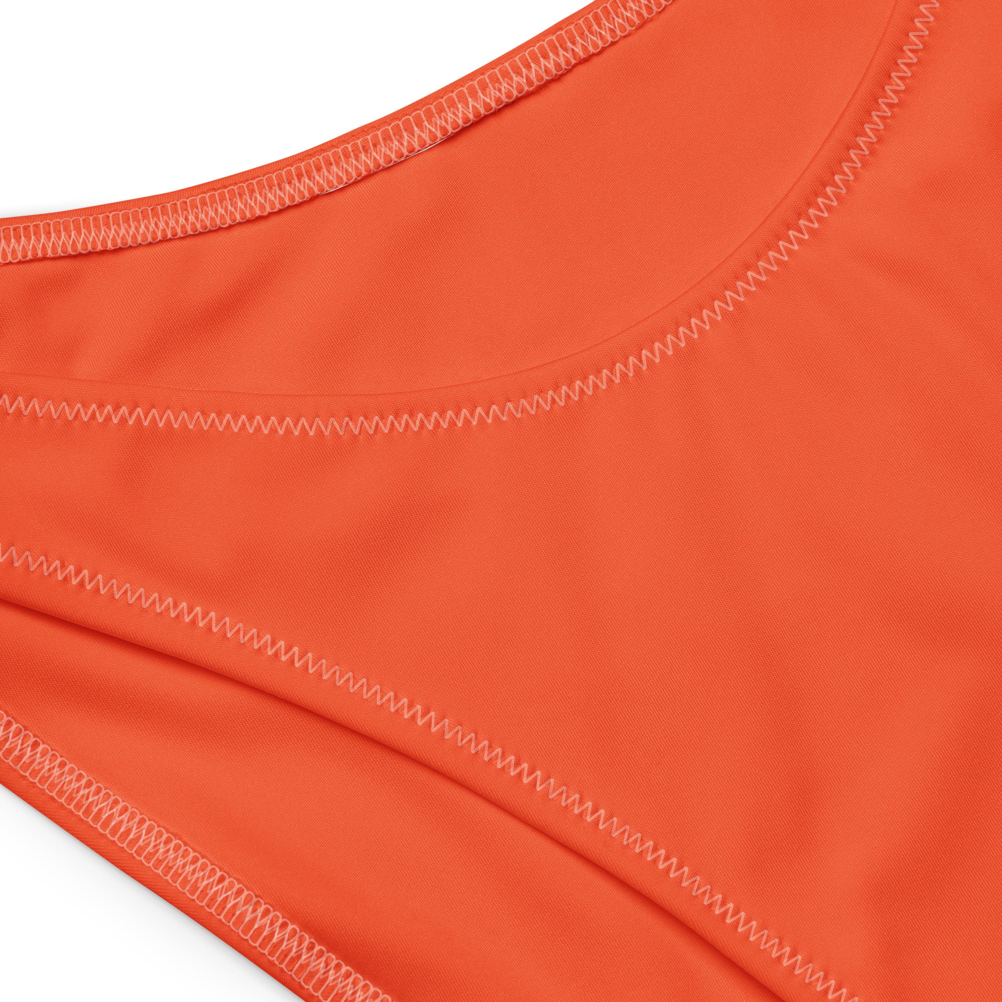 Bright orange women’s recycled bikini bottom with zigzag stitching made from quick drying fabric with UPF 50+ protection