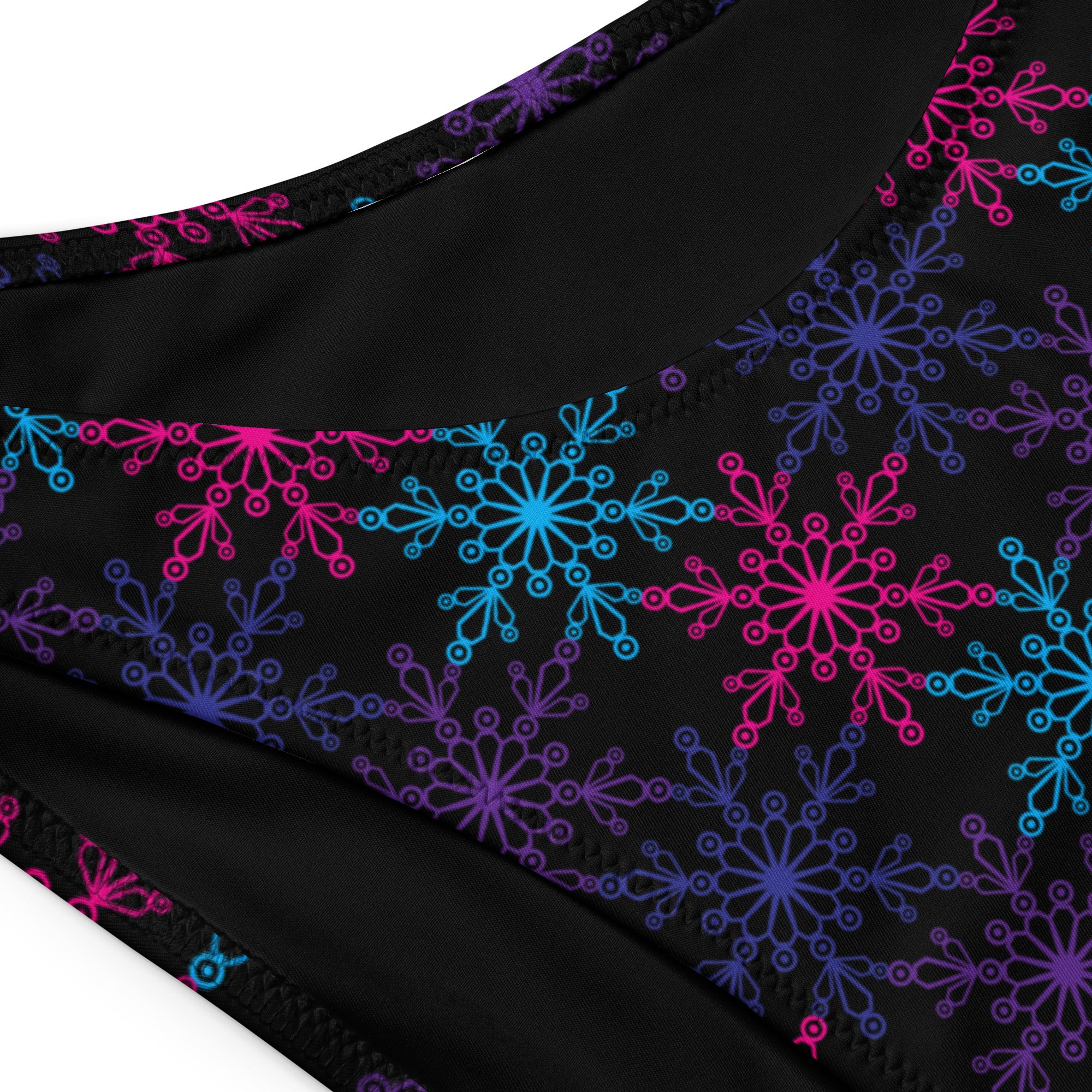 Women’s black neon snowflake recycled bandeau bikini bottom with vibrant pink blue and purple snowflake pattern