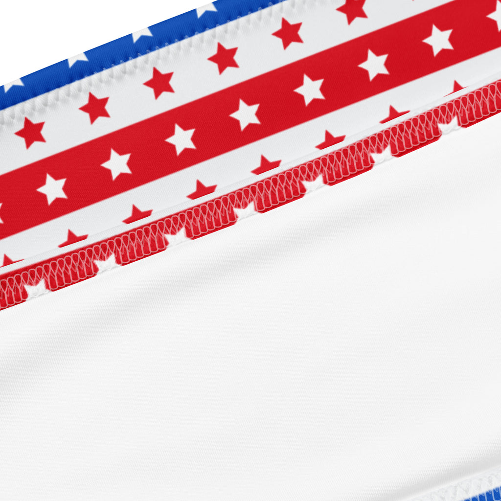 White fabric with red and blue stripes and stars on a women’s recycled quick drying bandeau bikini with stitched edge