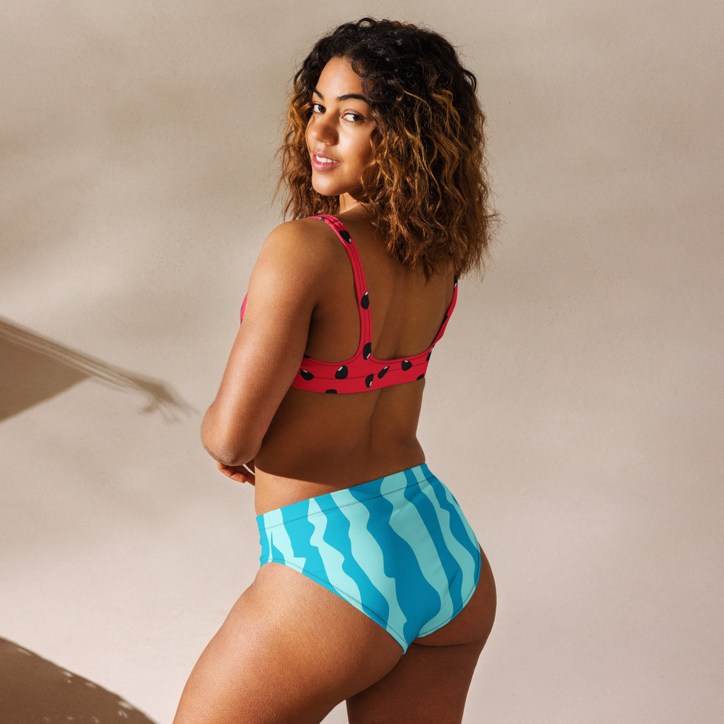 A vibrant women’s watermelon padded recycled bikini with a pink polka dot top and blue high-waisted wavy bottoms