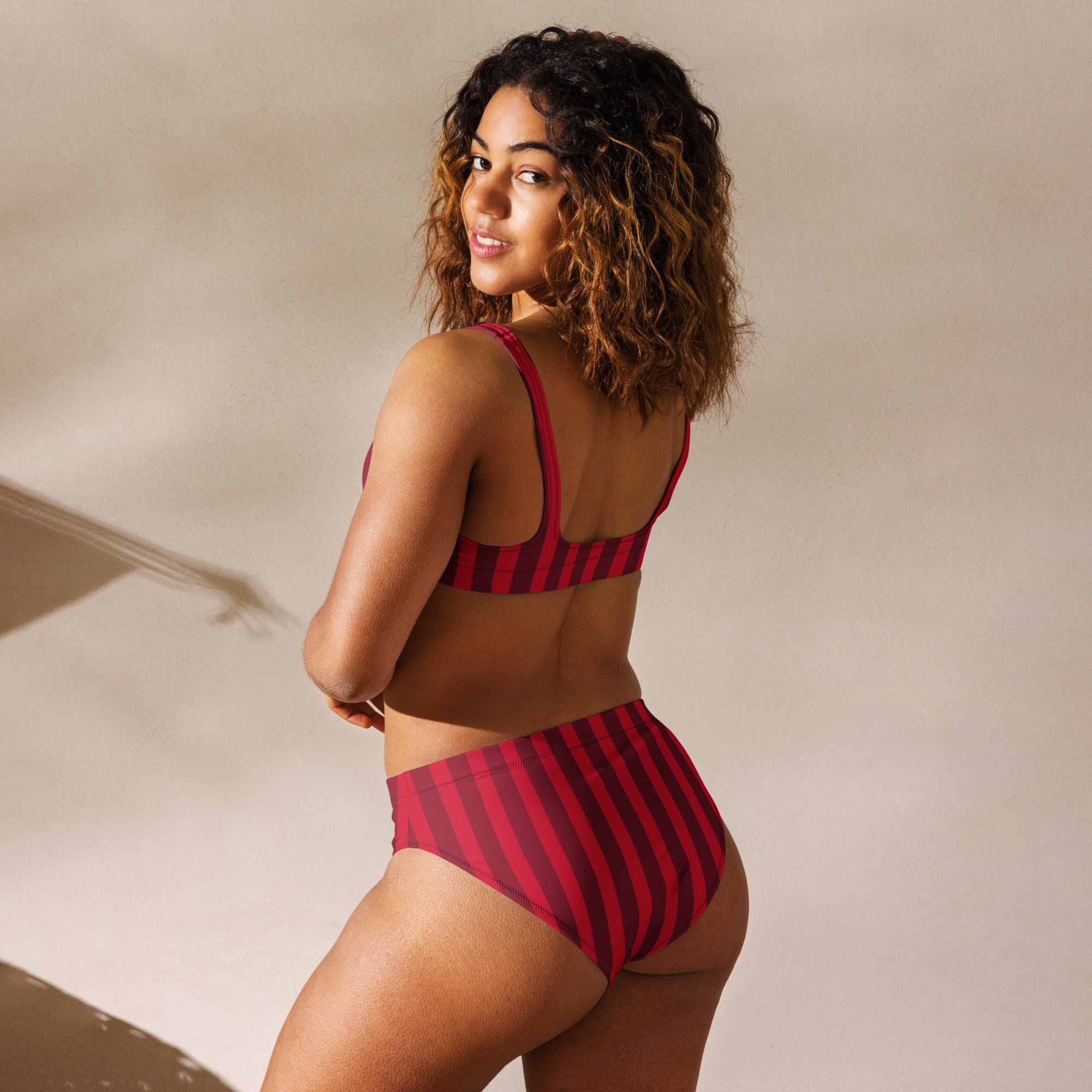 A vibrant deep red and black striped recycled bikini set with high waisted bottom and quick drying fabric upf 50+