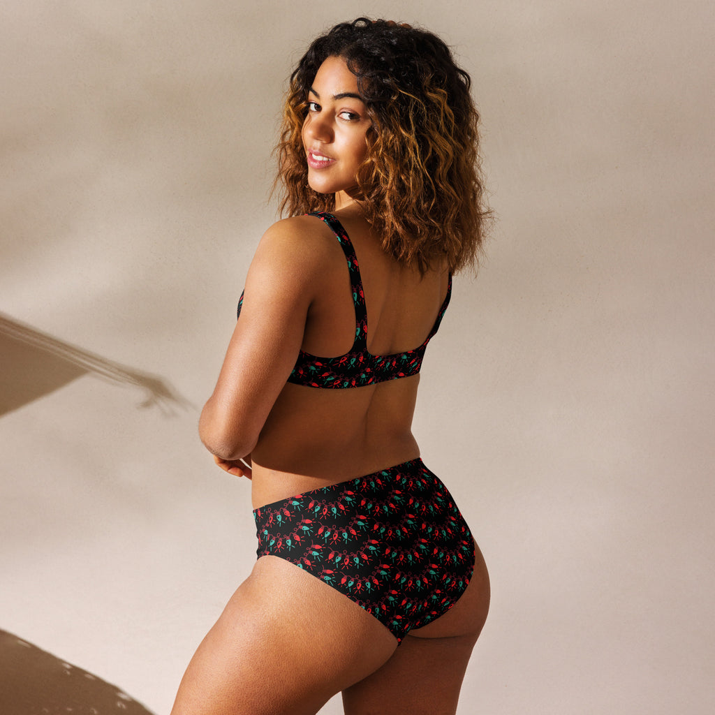 Women’s black bikini set with red and teal chili pepper pattern made from quick drying recycled fabric with upf 50+