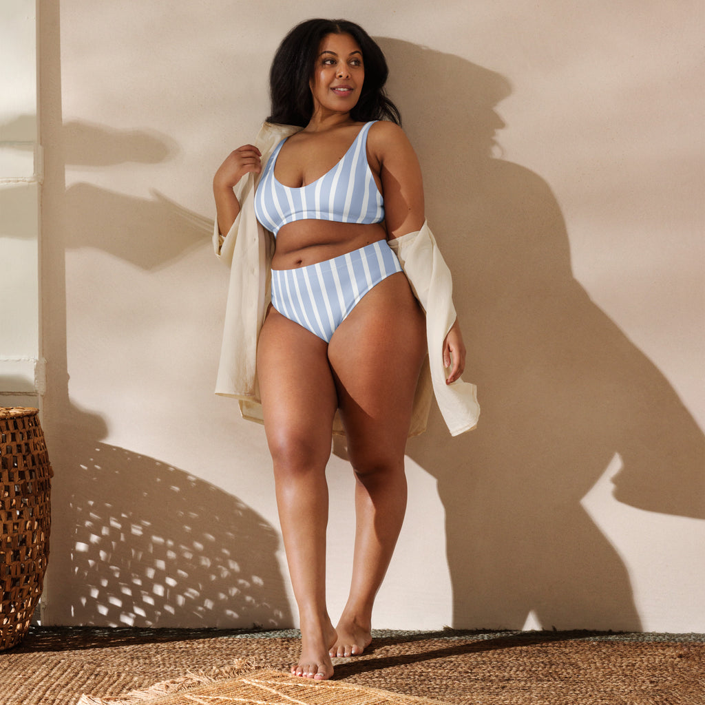 A plus-size woman wearing a women’s blue and white striped padded recycled bikini with high-cut bottoms and upf 50+ protection