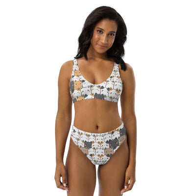 White two-piece bikini with kawaii cartoon cat faces in gray beige and black made from quick drying recycled fabric with upf 50+