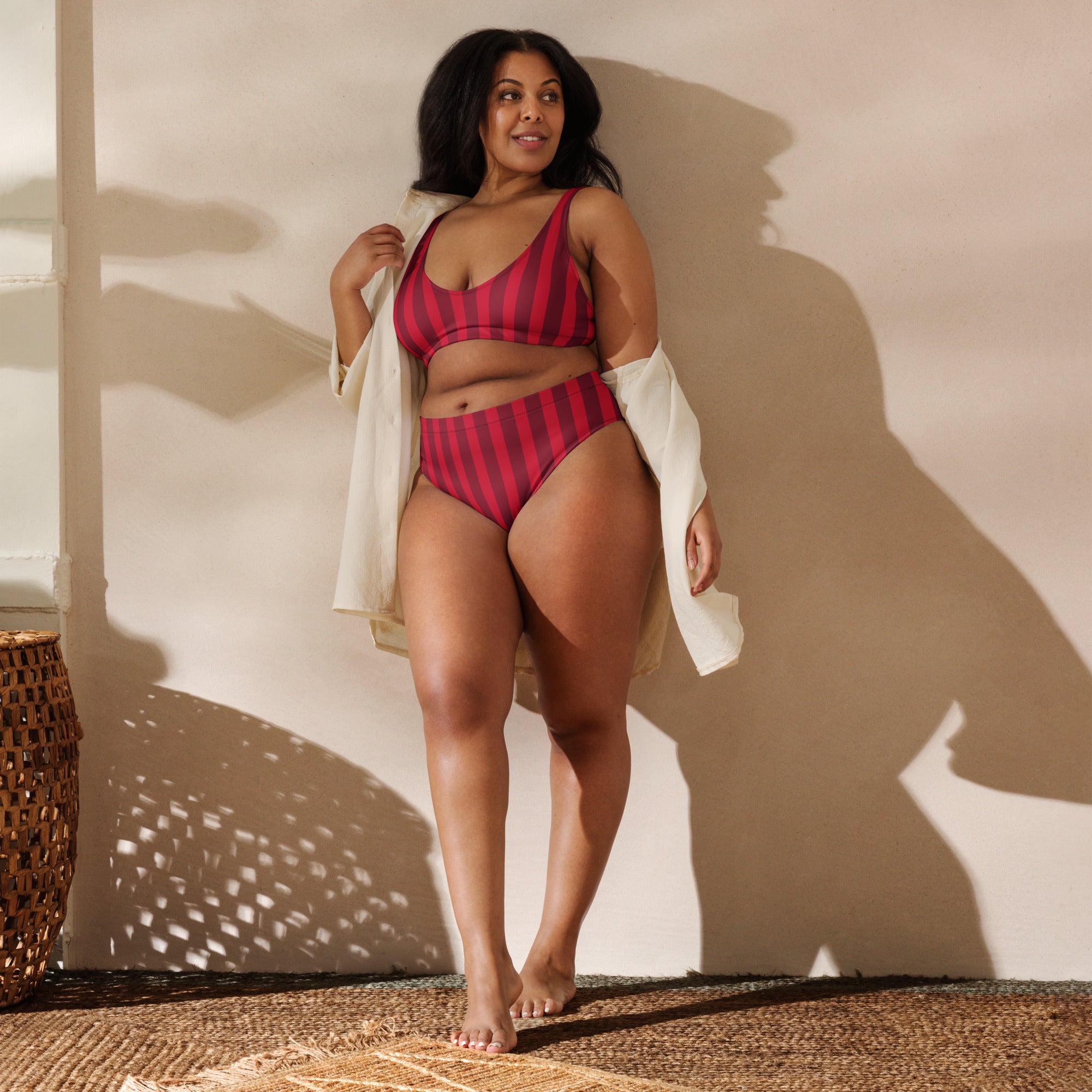 A plus-size woman wearing a women’s deep red stripe recycled two-piece bikini with upf 50+ quick drying fabric