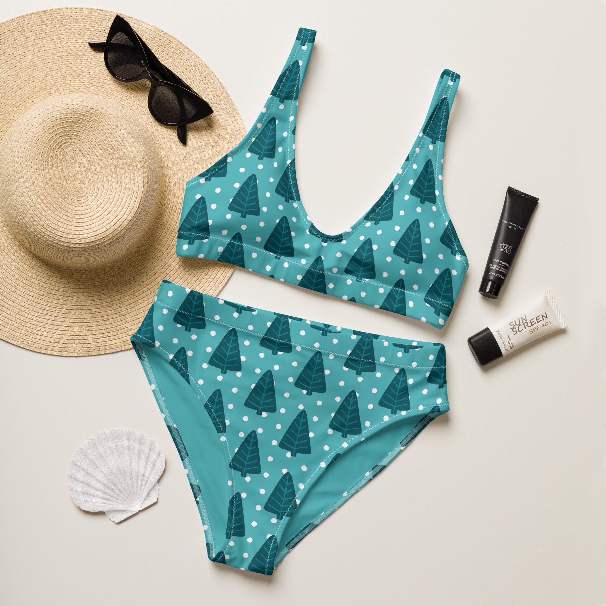 Women’s teal two-piece swimsuit with dark green tree and white polka dot pattern made from quick drying recycled fabric with upf 50+