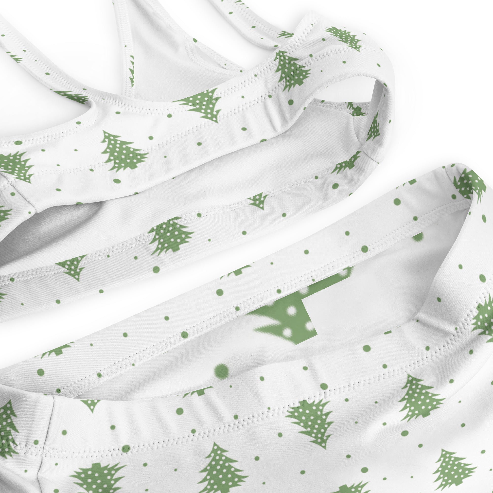 Woman’s white tank top with green pine tree and dot pattern made from quick drying recycled fabric with upf 50+