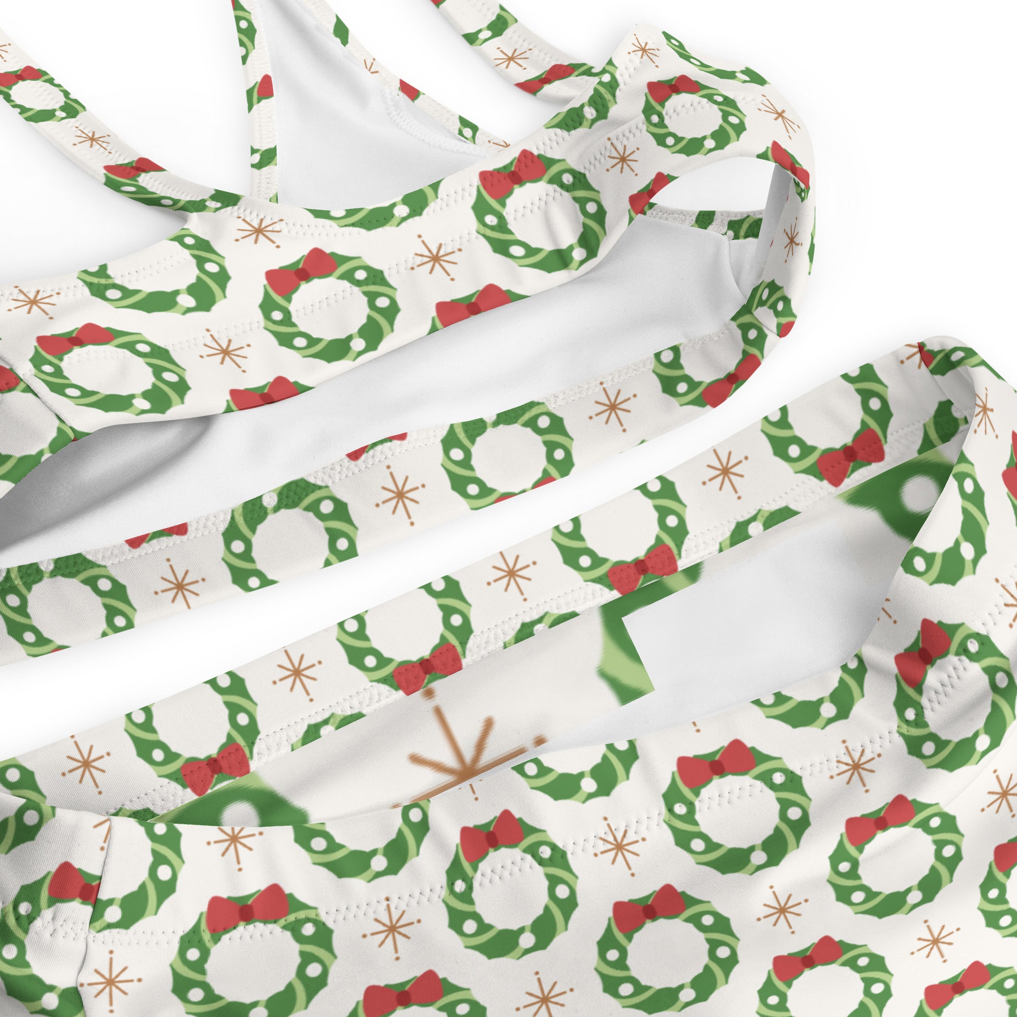 A festive white women’s Christmas wreath recycled bikini with green wreath patterns and quick drying UPF 50 plus fabric