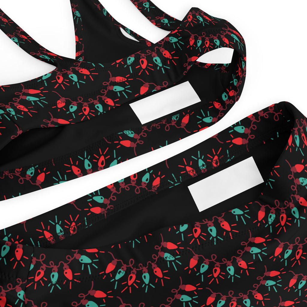 Black women’s sports bra with red and teal christmas light pattern made from quick drying recycled fabric with upf 50+