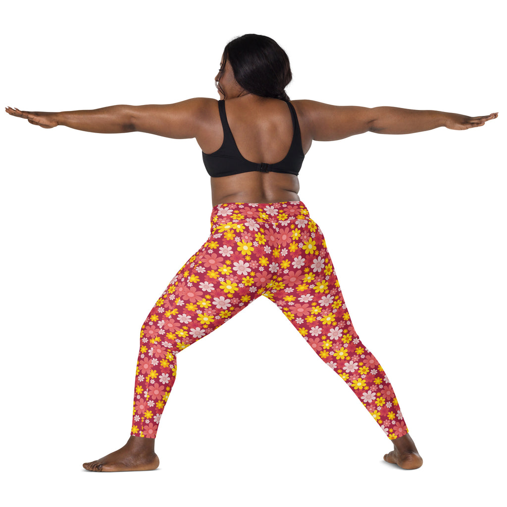 Women’s high-waisted pink floral yoga leggings with yellow and white flowers featuring pockets and soft compression fabric