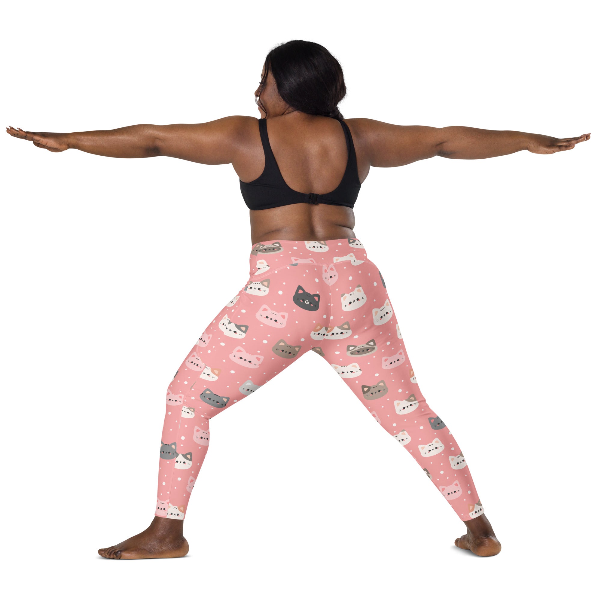 Women’s cute pink high-waisted yoga leggings with pockets featuring colorful cartoon cat faces and soft compression fabric