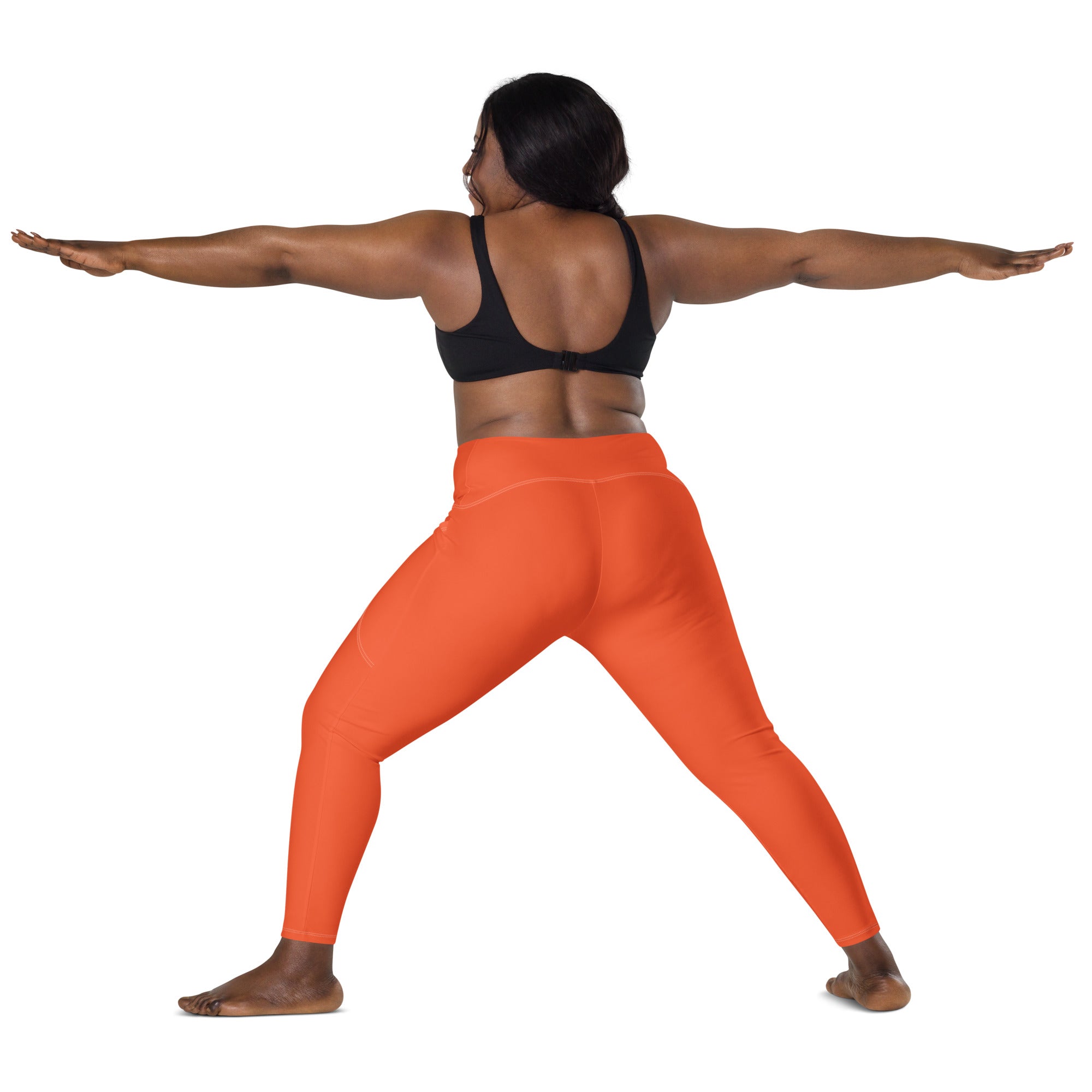 Bright orange high-waisted women’s yoga leggings with pockets made from smooth form-fitting stretch fabric