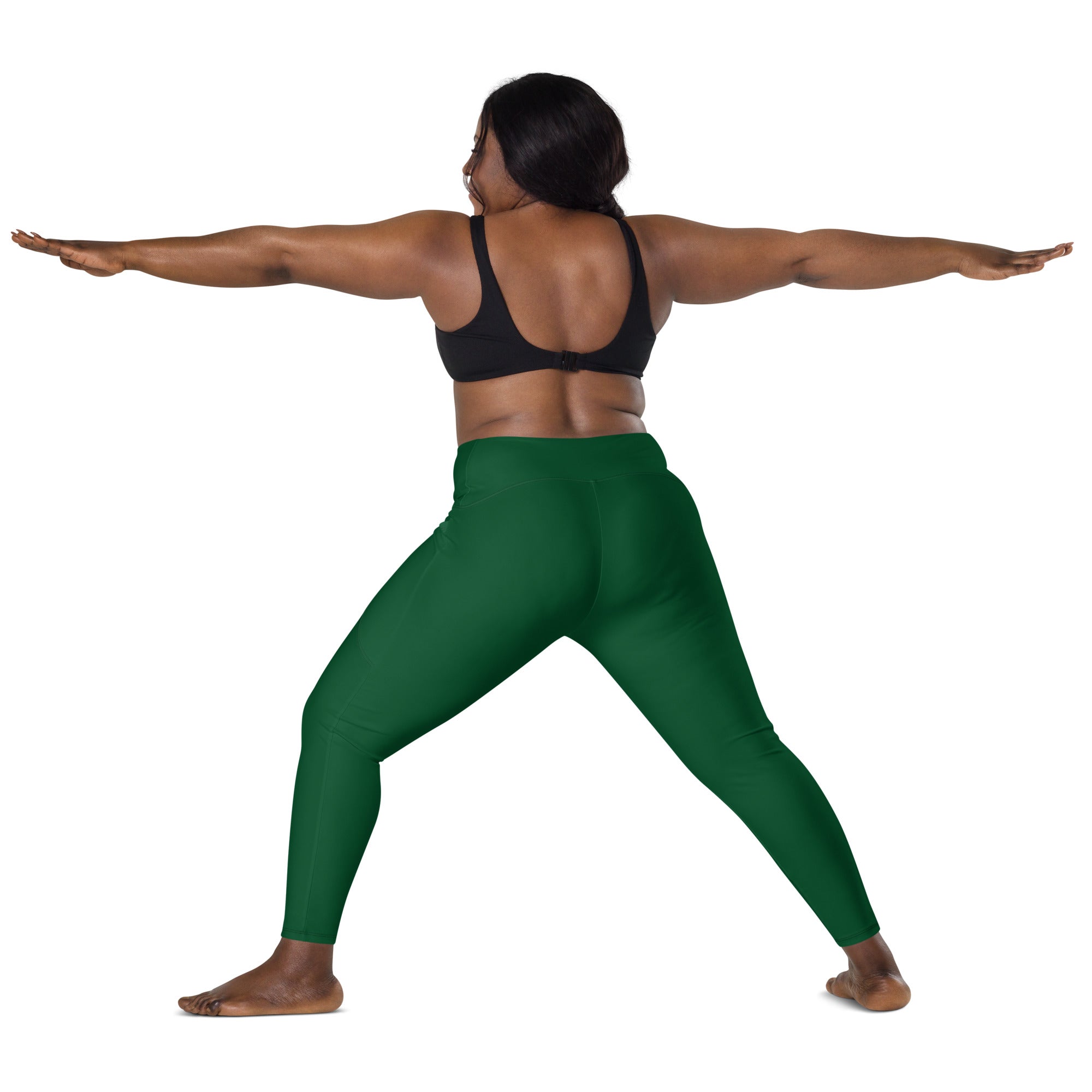 A pair of women’s dark green high-waisted yoga leggings made from stretchy soft compression fabric with pockets