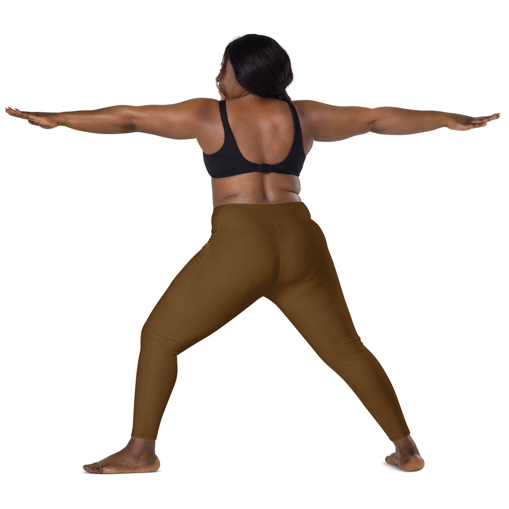 A woman wearing form-fitting brown high-waisted yoga leggings with pockets in a yoga pose