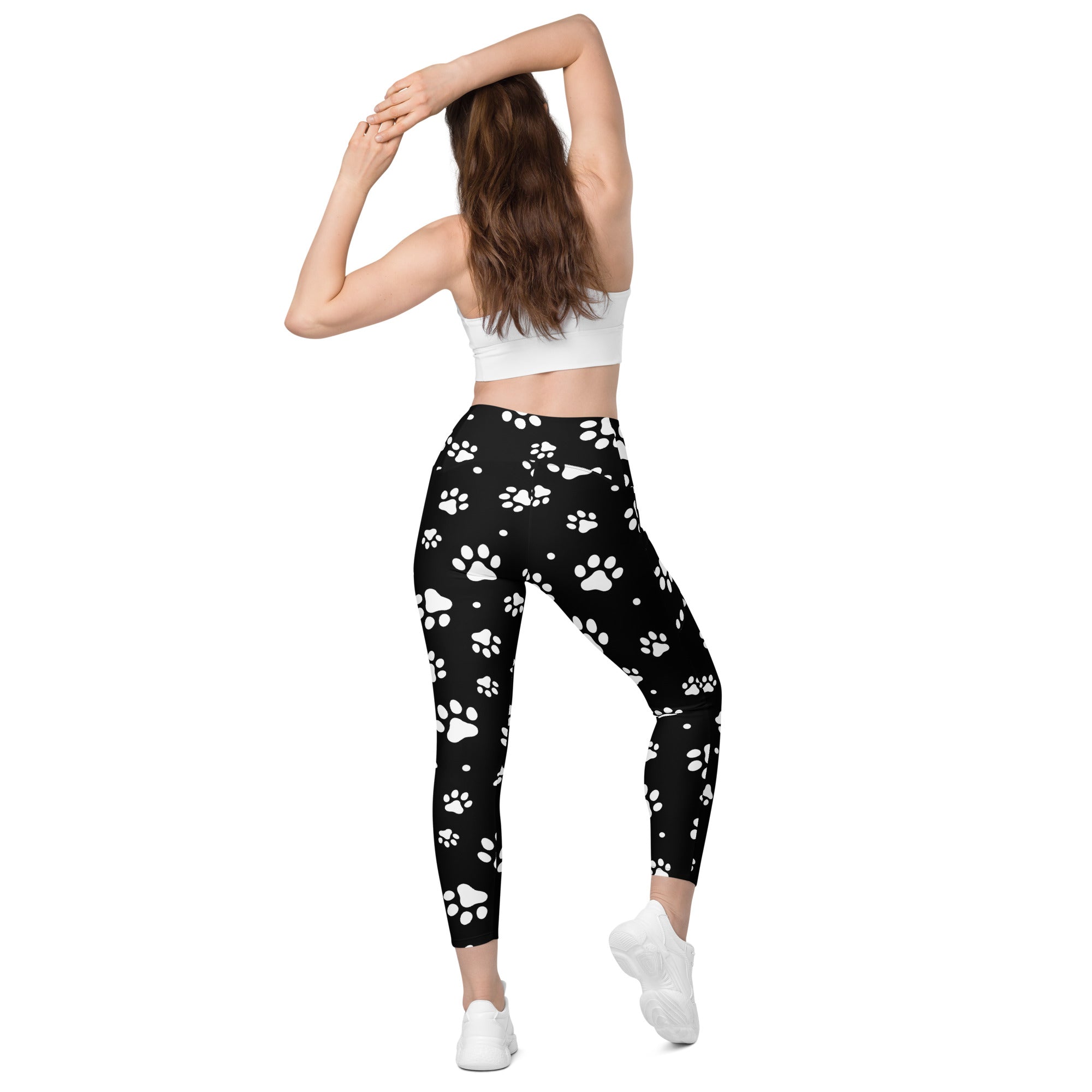 Black high-waisted women’s yoga leggings with white paw print pattern soft compression fabric and pockets