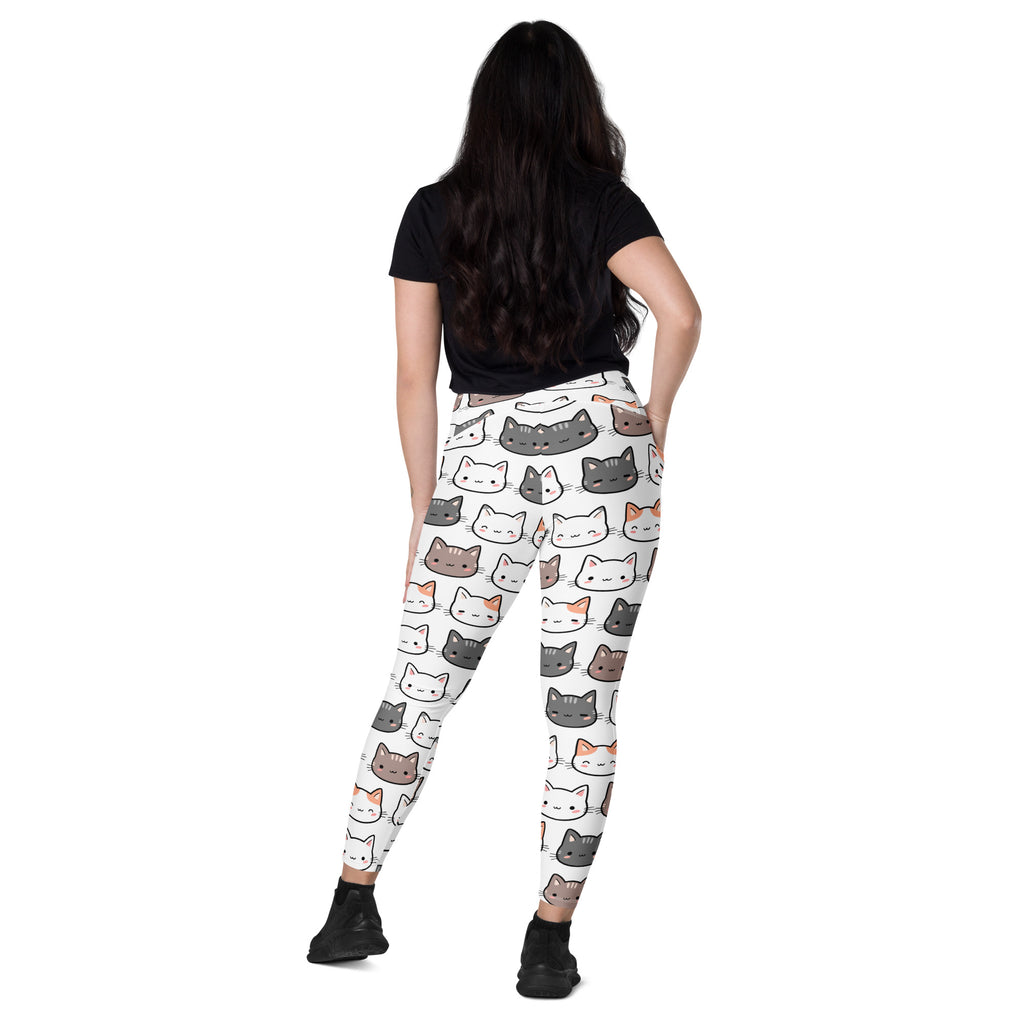 White high-waisted leggings with pockets featuring a playful multicolor cartoon cat pattern for yoga and active wear