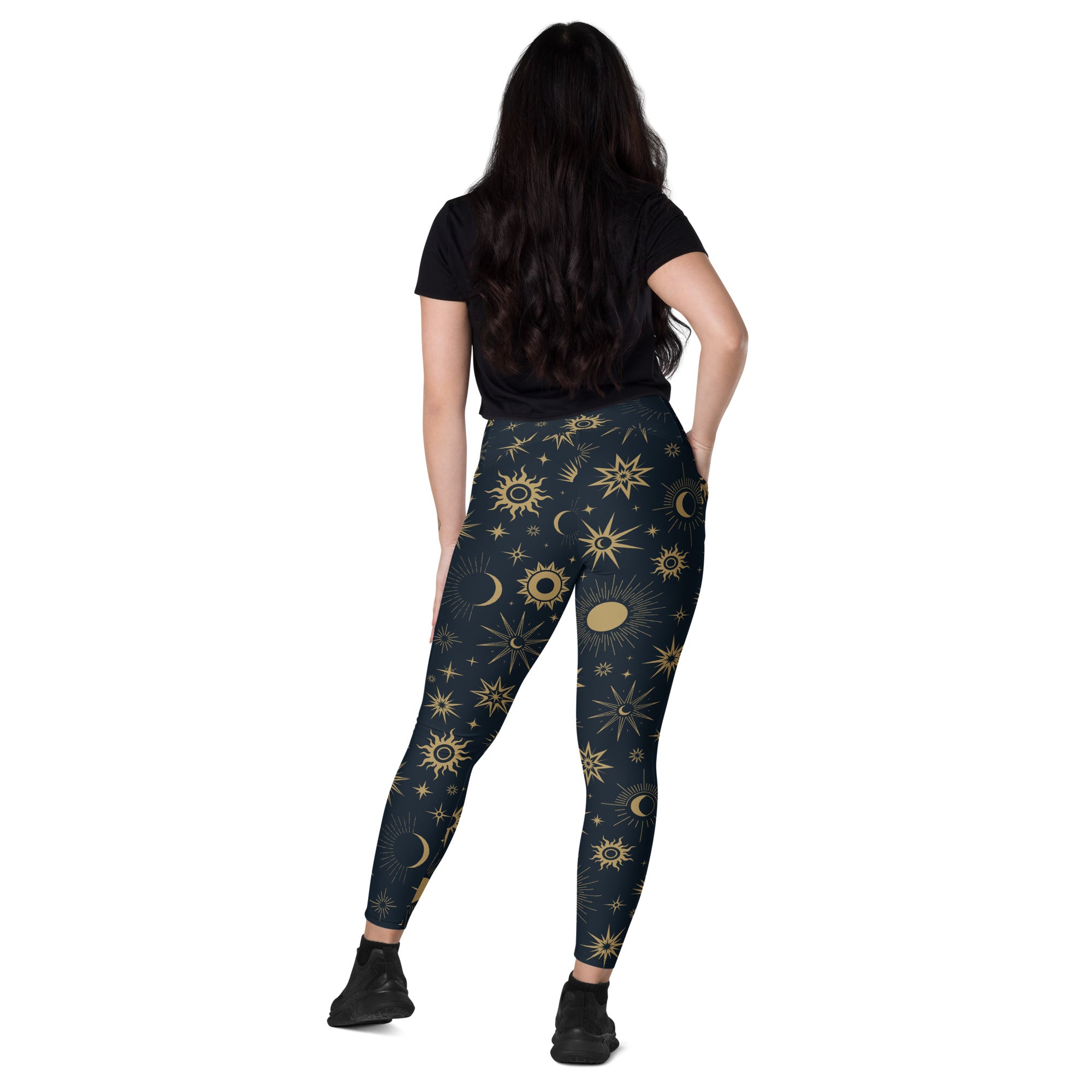 Dark blue high waisted women’s yoga leggings with soft compression and vibrant gold suns moons and stars pattern