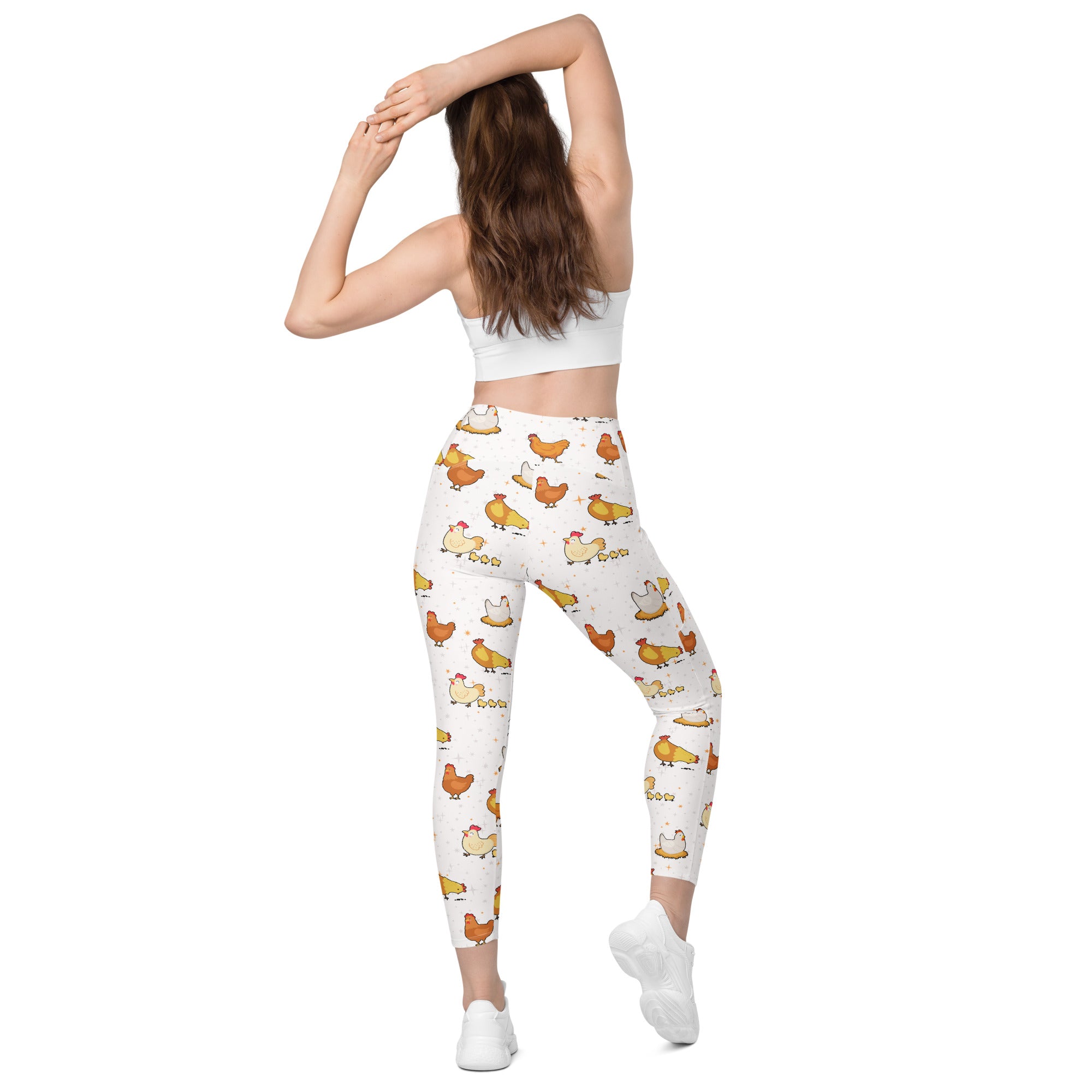 White high-waisted women’s chicken yoga leggings with pockets featuring a playful orange and yellow cartoon chicken pattern