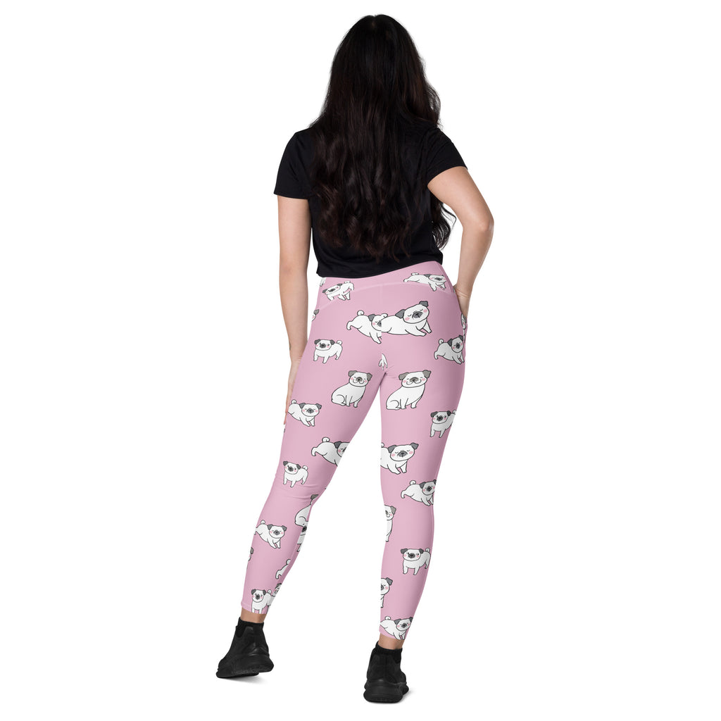 Women’s pink high-waisted yoga leggings with pockets featuring white cartoon pug pattern and soft compression fabric