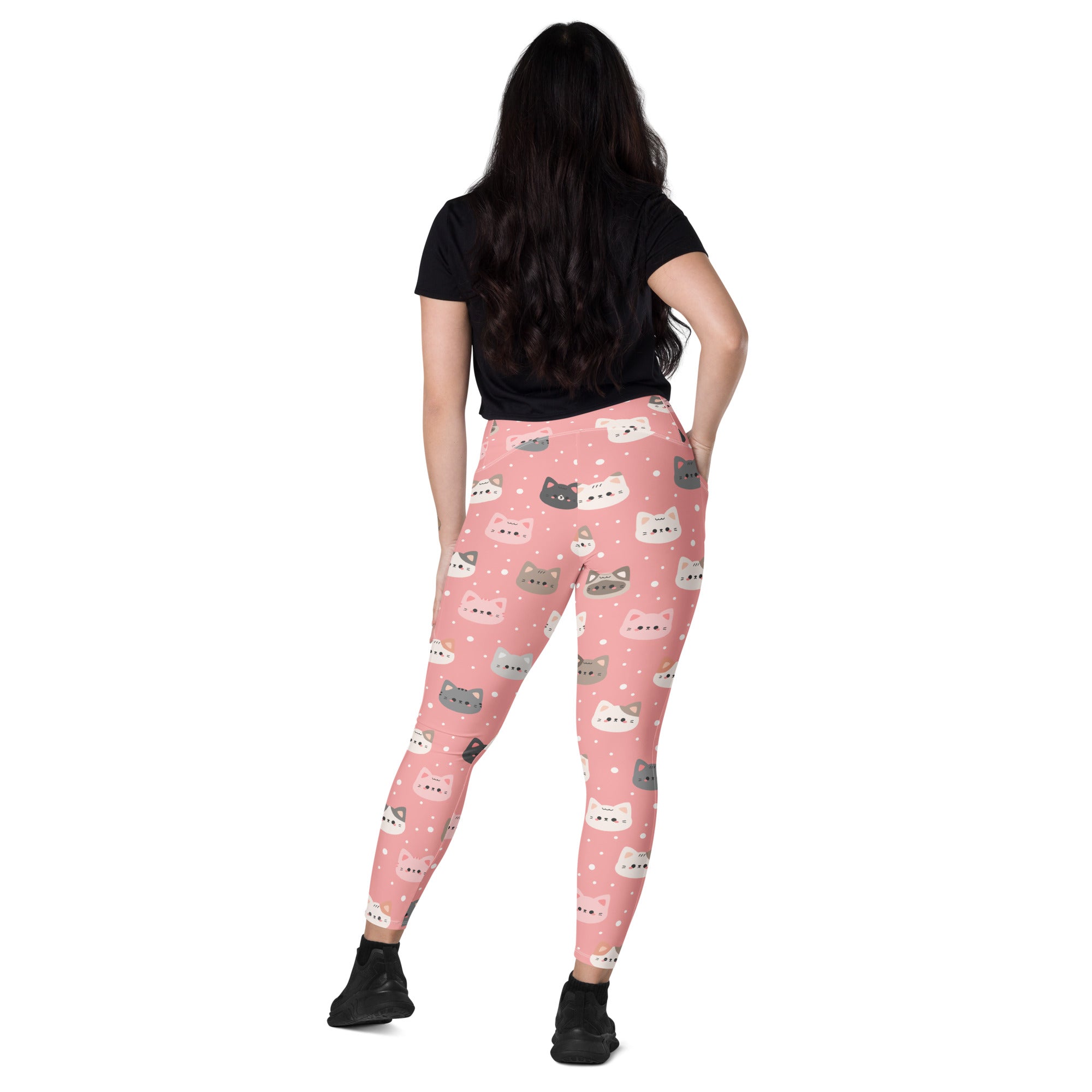 Women’s high-waisted pink yoga leggings with soft compression and colorful cartoon cat patterns and pockets