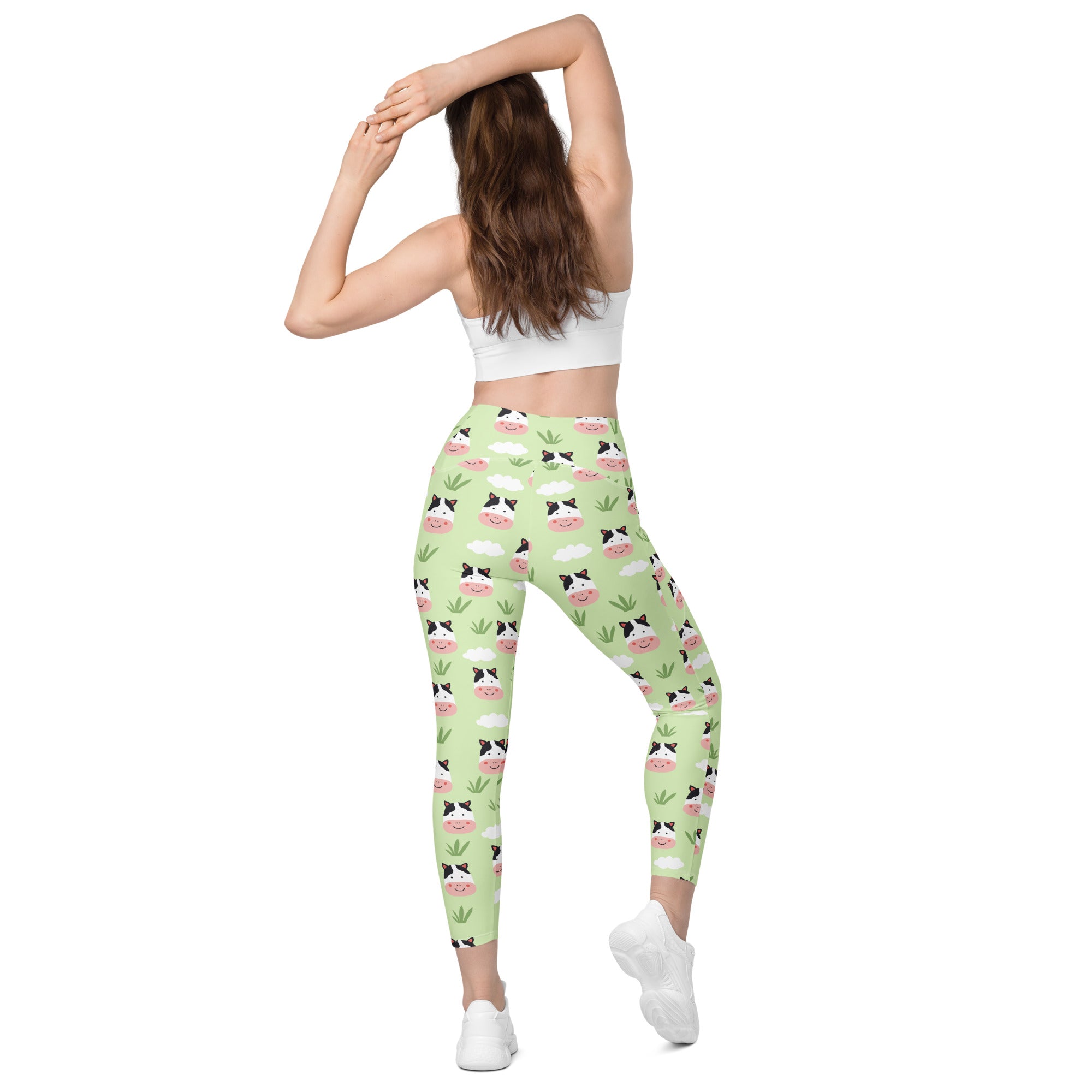 Women’s light green high-waisted soft compression yoga leggings with pockets featuring cartoon cow faces and plants pattern