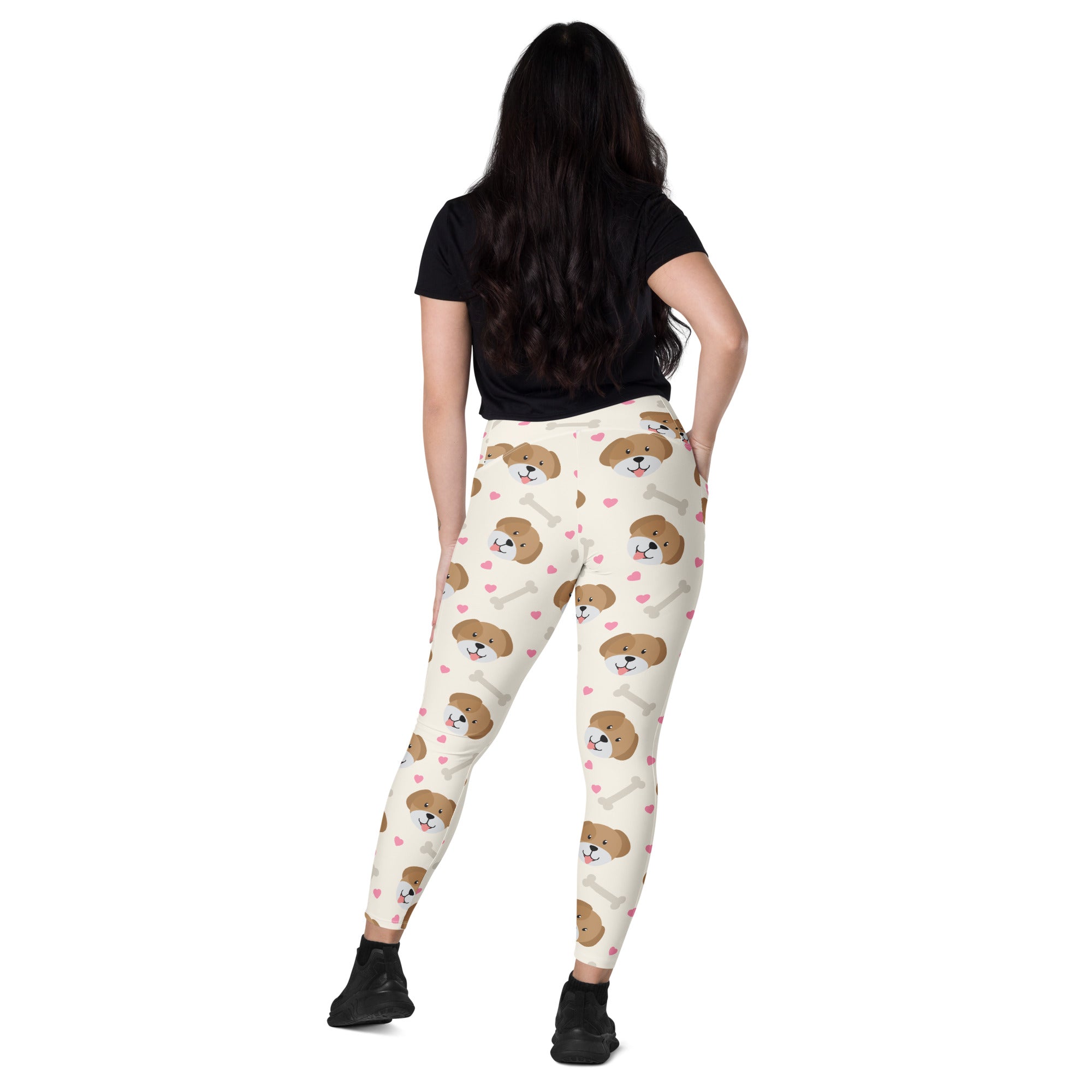Cream-colored women’s high-waisted dog yoga leggings with pockets featuring brown puppy faces pink hearts and white bones