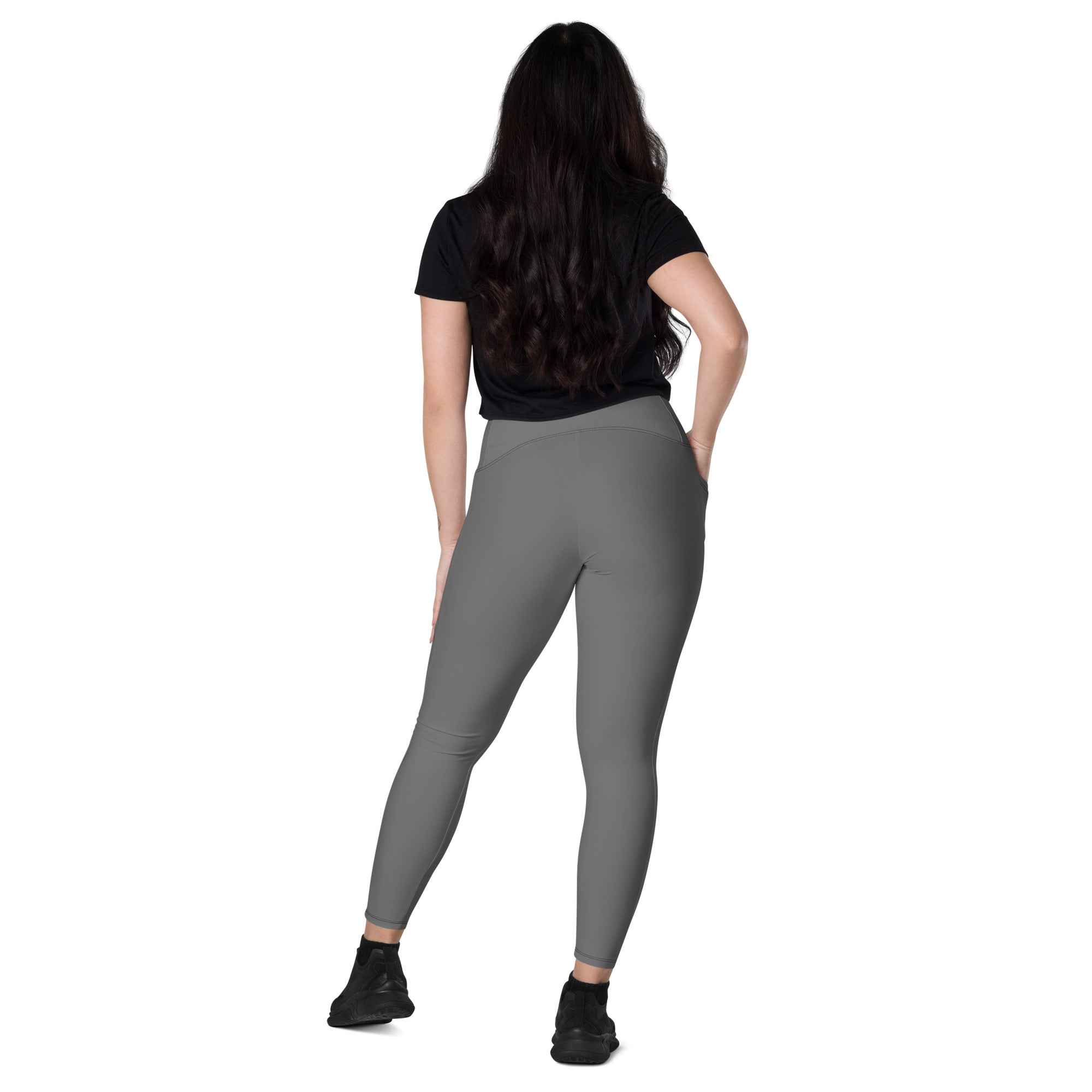 Women’s gray high-waisted yoga leggings with pockets made of smooth stretchy fabric and subtle seam detailing