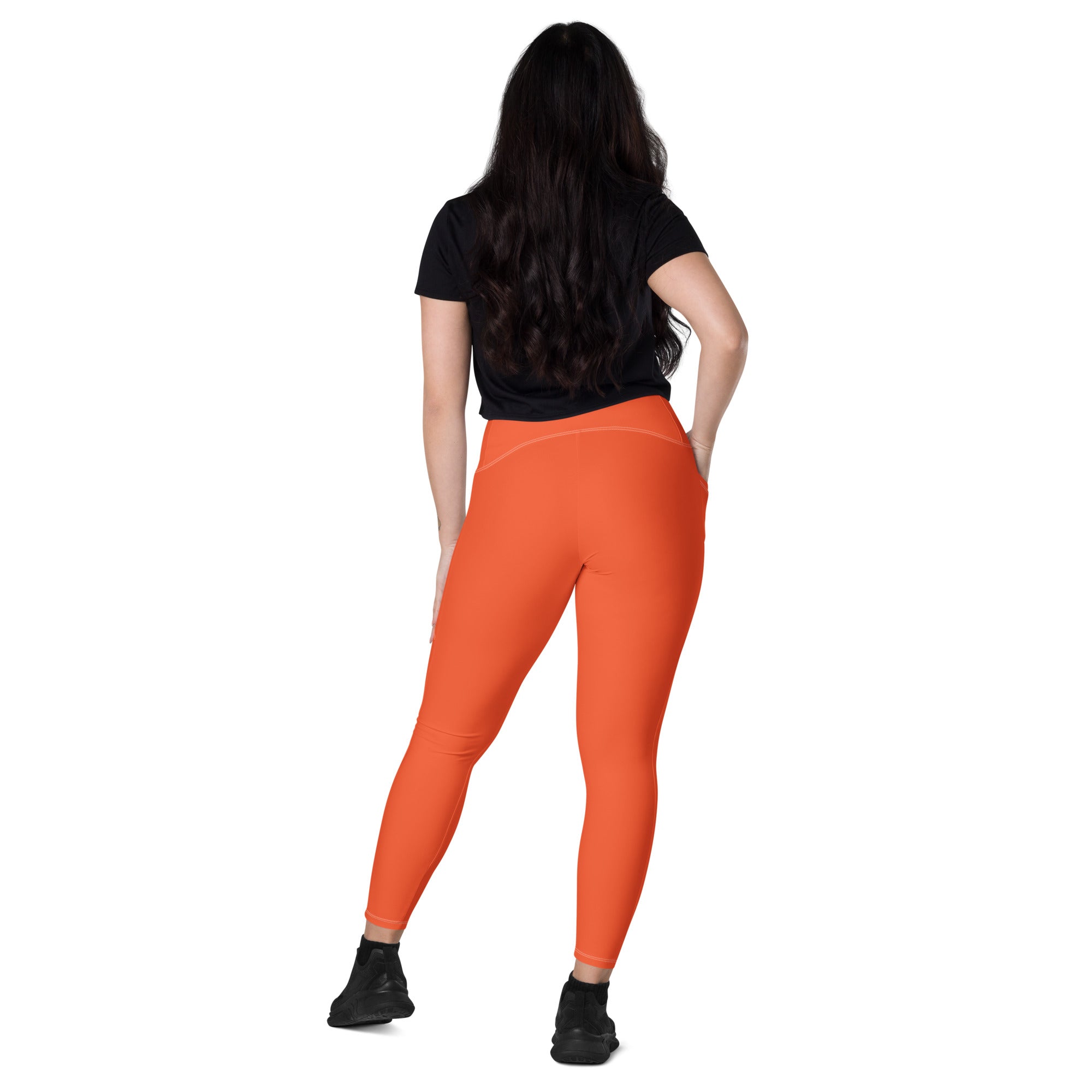 Bright orange high-waisted yoga leggings with pockets made of stretchy soft compression fabric for women