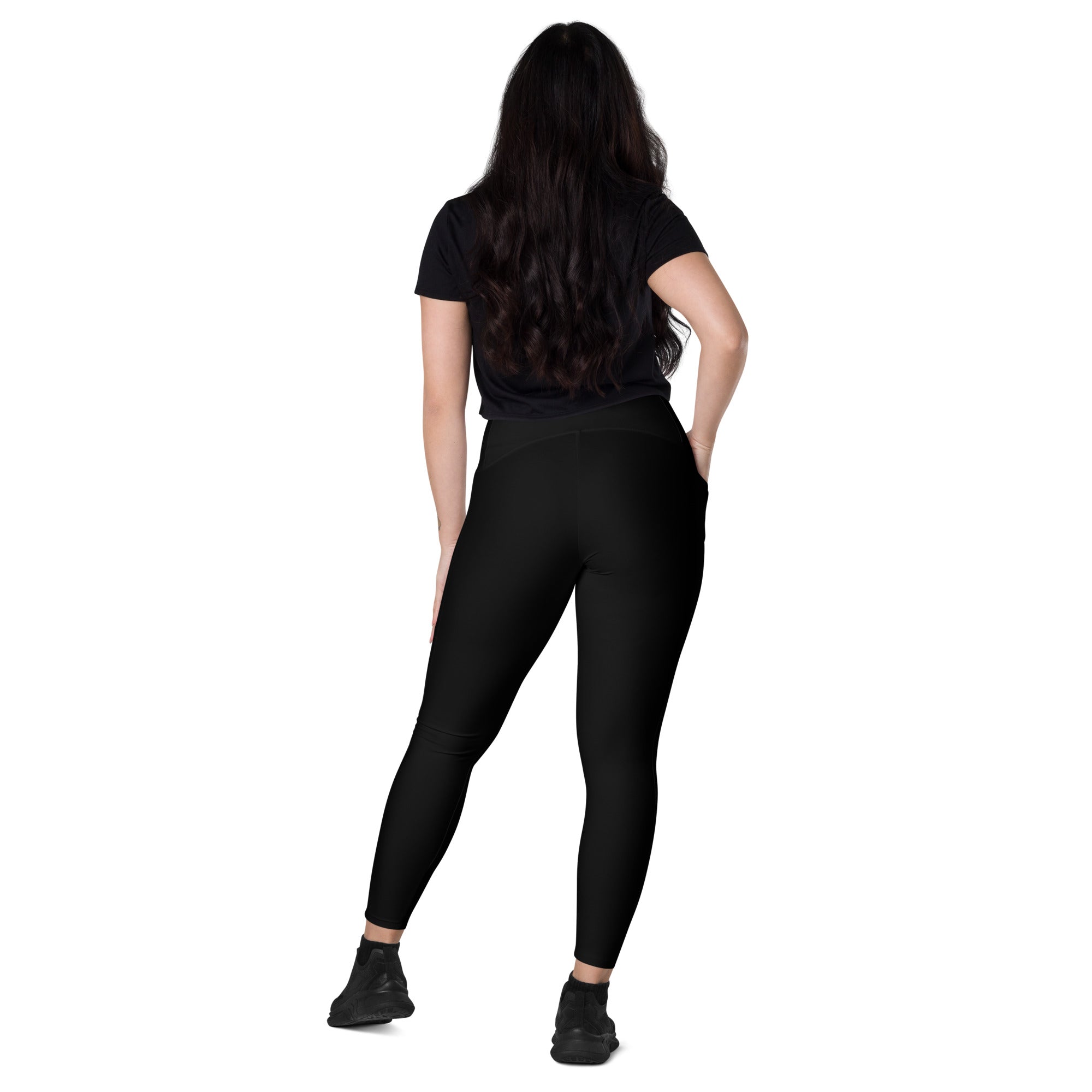 Women’s black high-waisted yoga leggings with pockets made of smooth, soft compression fabric with subtle seams