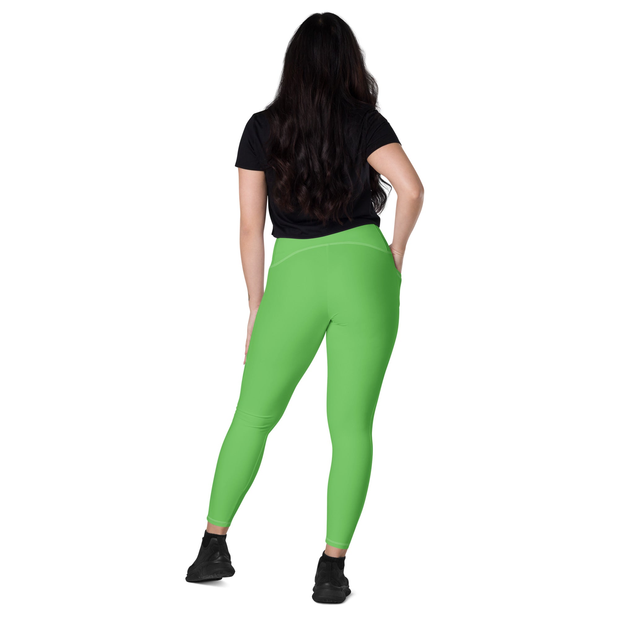 Women’s bright green high-waisted yoga leggings with pockets made of stretchy soft compression fabric