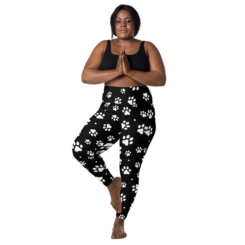 Black high-waisted women’s yoga leggings with white paw print pattern soft compression fabric and pockets