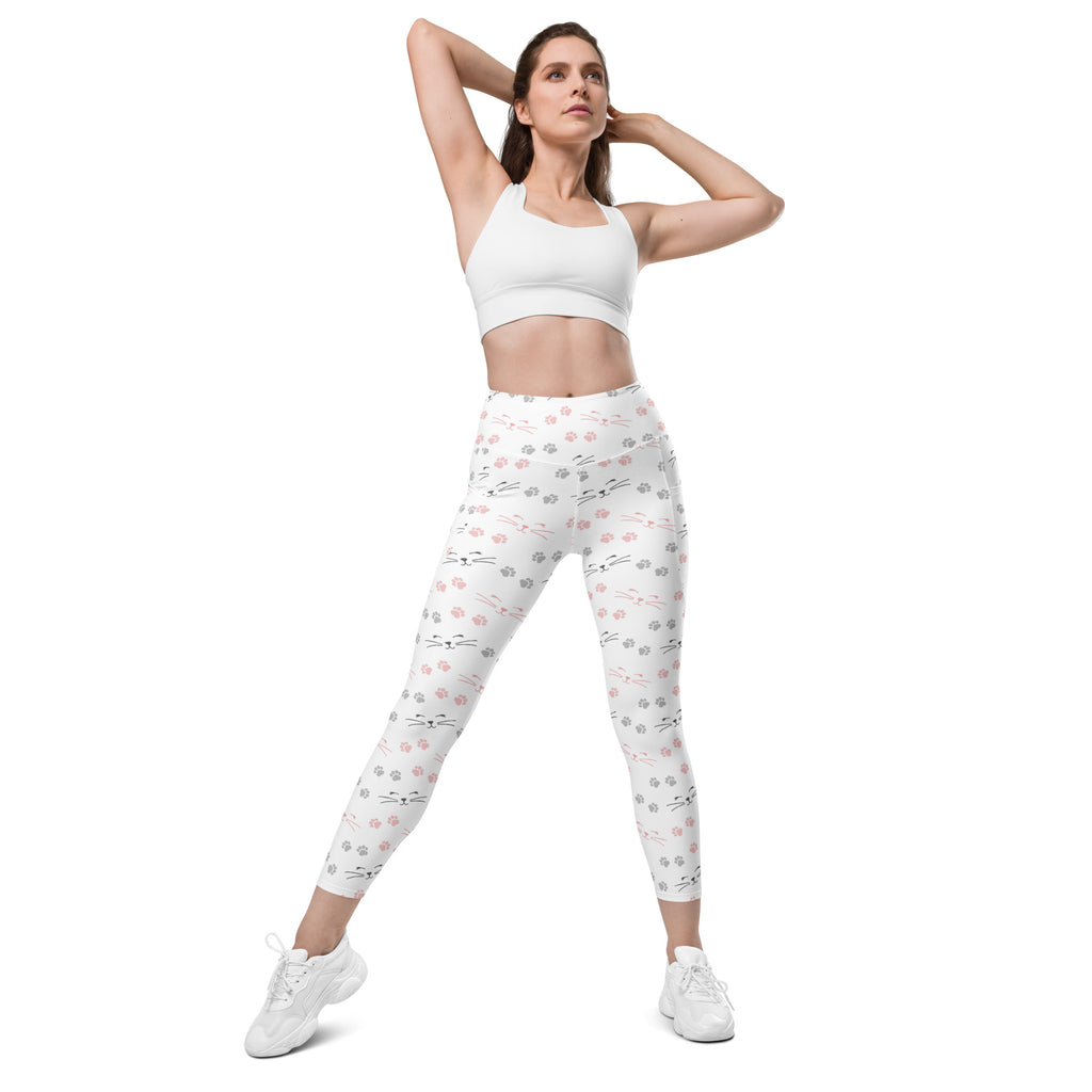 Women’s high-waisted white leggings with pockets and playful pink and gray cat face pattern for yoga and activewear