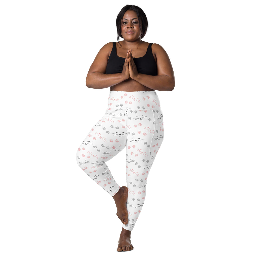 White high-waisted yoga leggings with soft compression featuring pink and gray cat faces and paw prints with pockets
