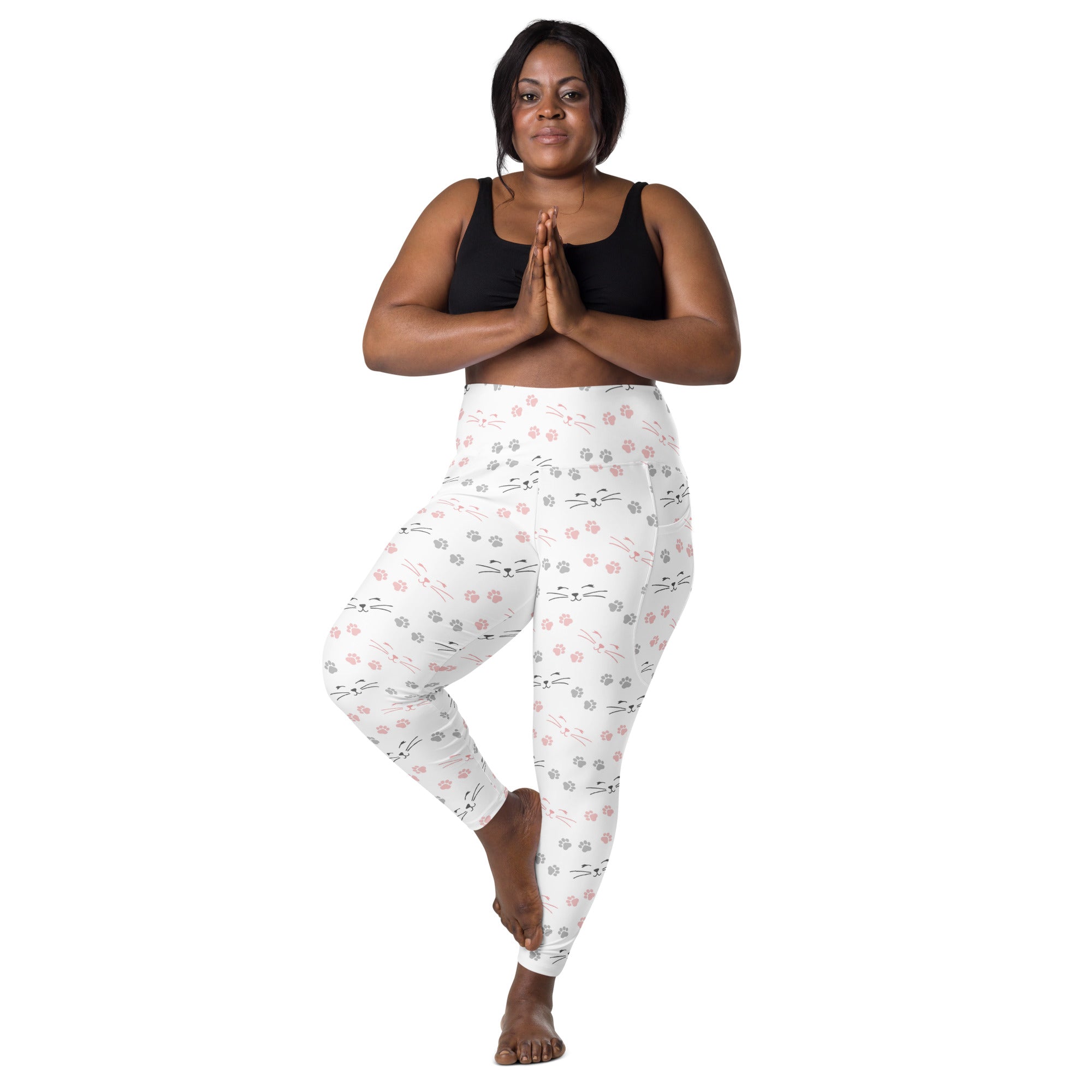 White high-waisted yoga leggings with soft compression featuring pink and gray cat faces and paw prints with pockets